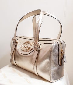 New Gucci gold and silver leather bag with certificate