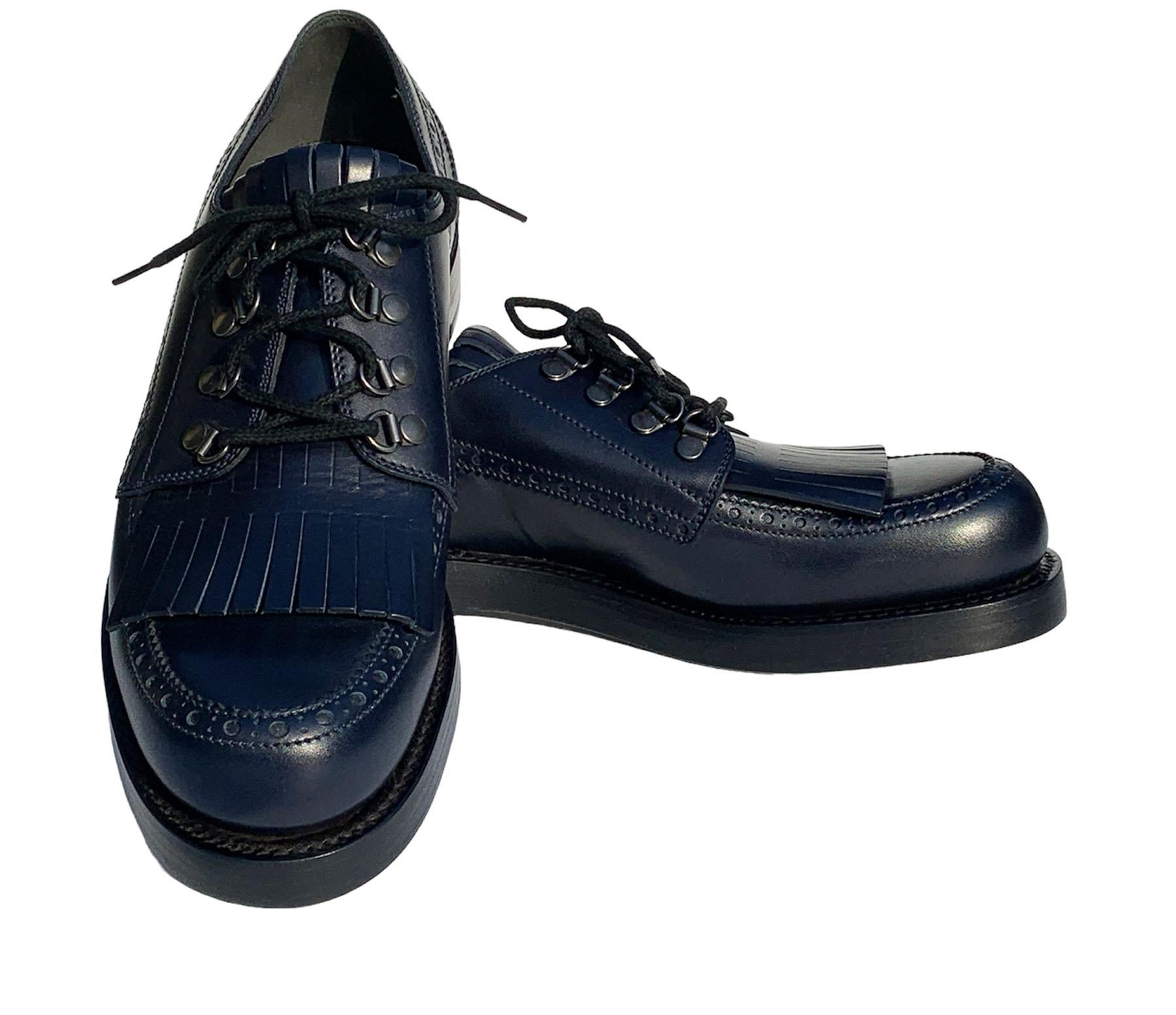 Gucci Men's Leather Fringed Brogue Lace-Up Shoes Dark Blue 
Gucci size 9 ( US 10 )
Mixing classic notes, such as brogueing and a hand-cut fringe, with unexpected touches, such as a stacked leather sole and metal loops, these lace-ups command