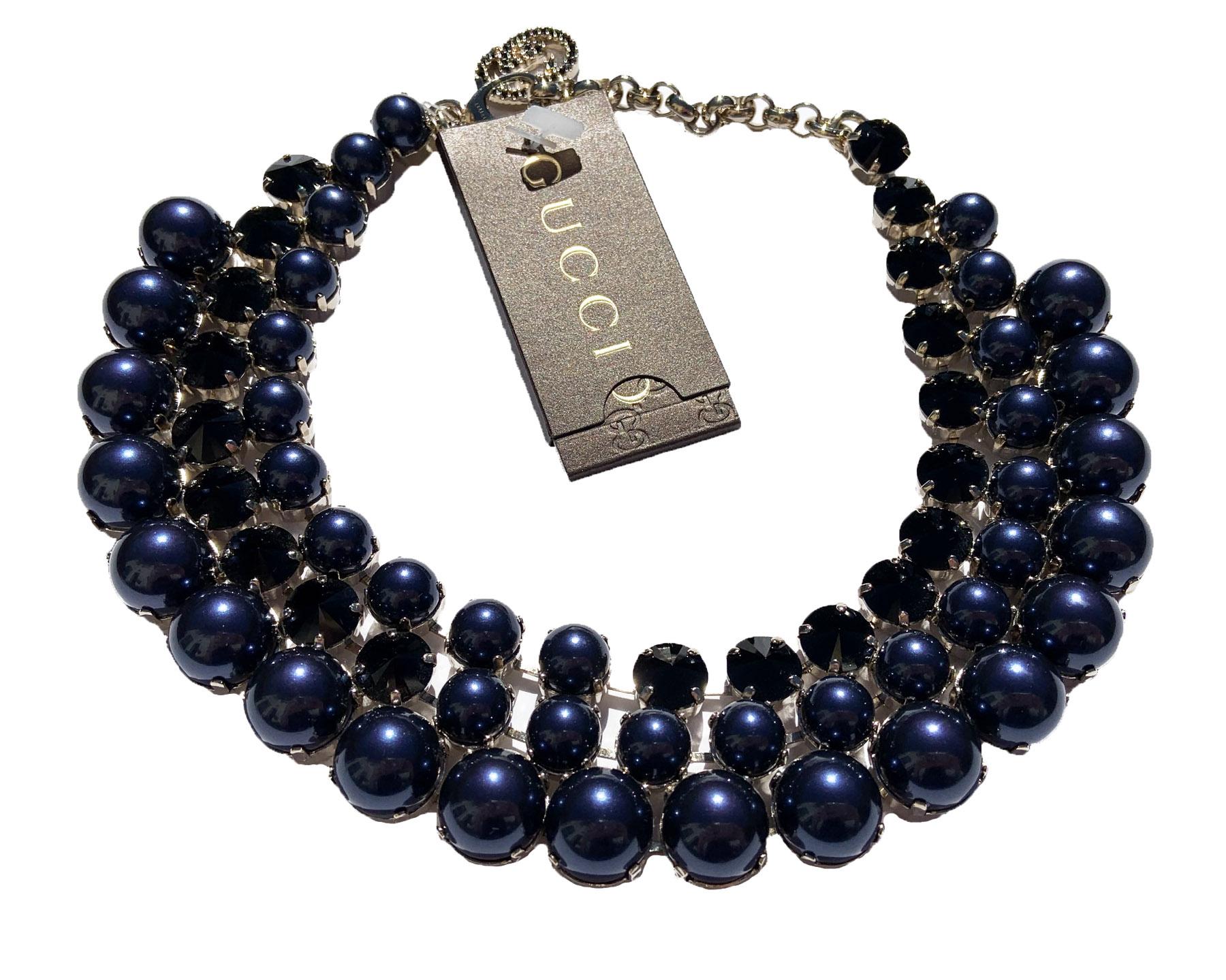 New Gucci Navy Blue and Black Necklace
Intricately Crafted with Blue Pearl Effect Glass and Black Swarovski Crystals.
Adjustable Lobster Clasp Closure with Crystal Interlocking G Detail.
Gold-tone Metal Hardware, Engraved *Gucci* Brand on Back.