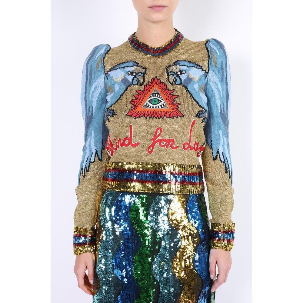 Gucci's metallic-gold wool-blend sweater is expertly woven in Italy with a tonal-blue parrot intarsia, 
and finished with puffed shoulders that cleverly sculpt the wings.
Mid-weight knit.
Tonal-blue, black, brown, white and metallic-gold wool-blend