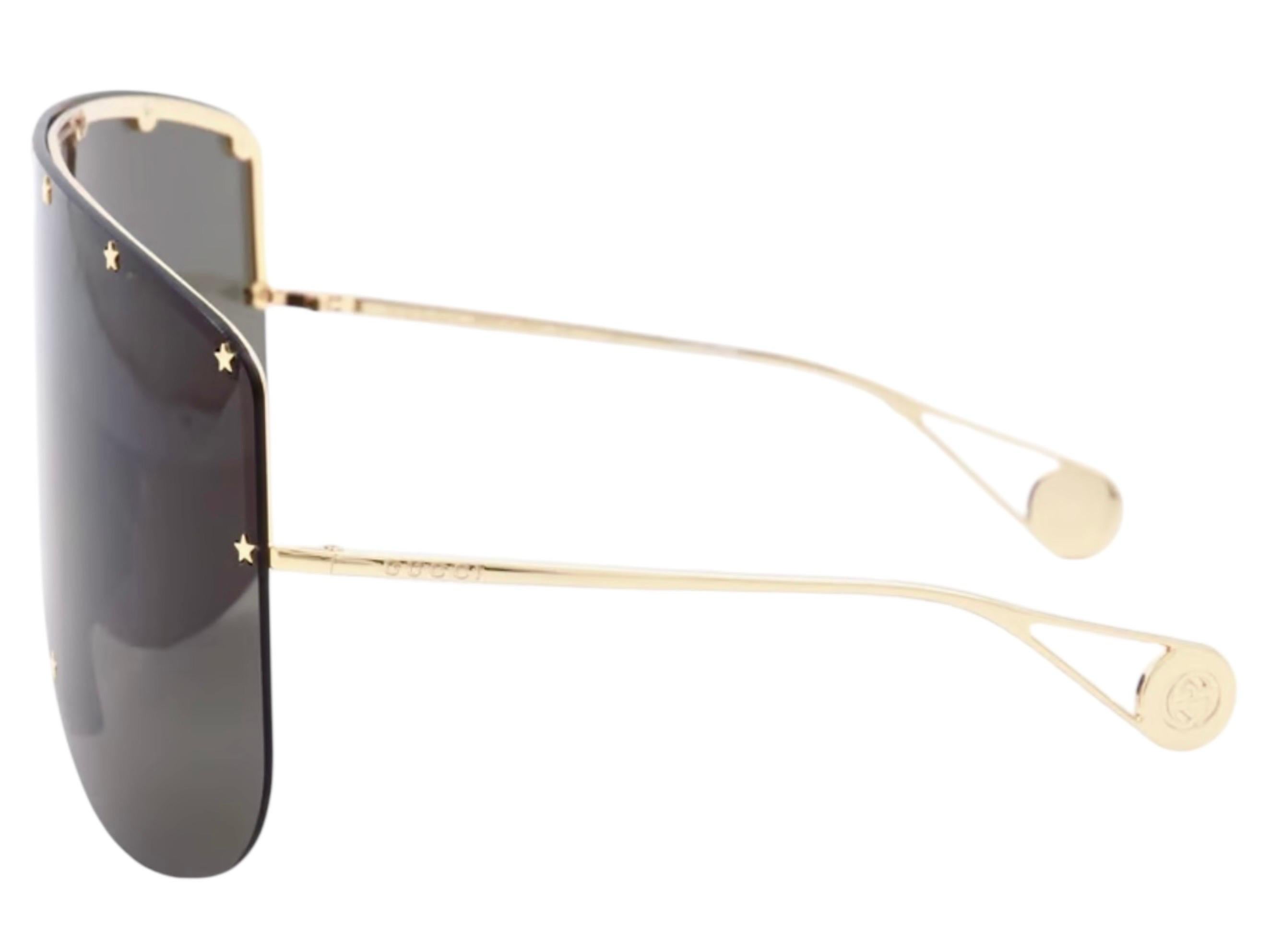 Con un design unico, questi occhiali da sole oversize Gucci ti rendono una star in ogni occasione. Le lenti poggiano su una montatura metallica nascosta e sono profilate sul davanti da rivetti a forma di stella che conferiscono all'accessorio una