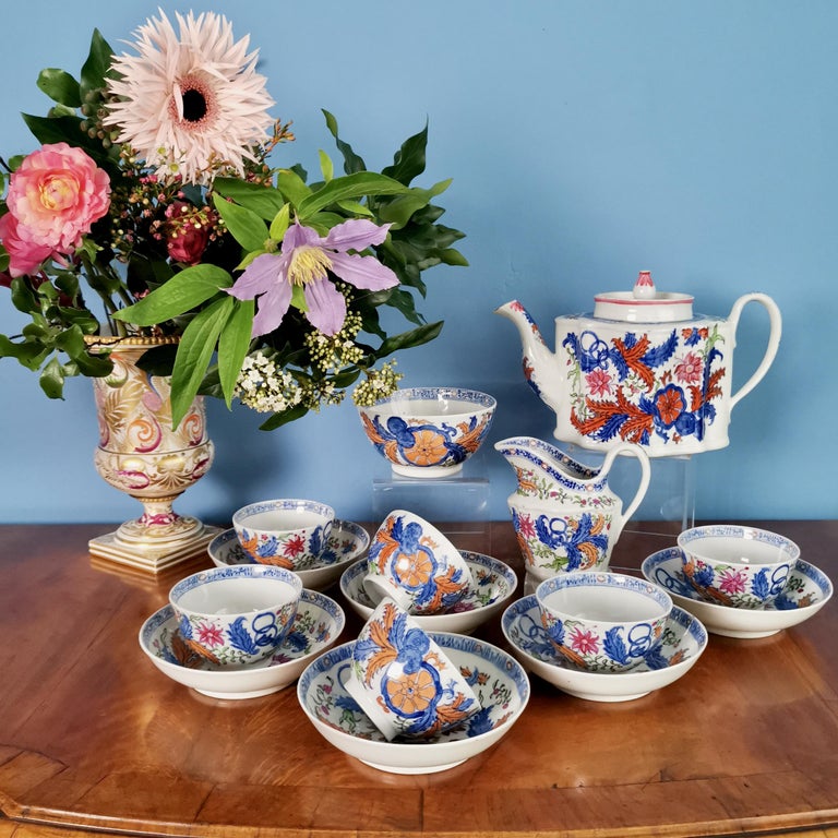 This is a stunning tea service made by New Hall in circa 1795. The service is made of hybrid hard paste porcelain and decorated in a bold Chinoiserie pattern of large flower sprays. The service consists of a teapot with cover, a milk jug, a slop