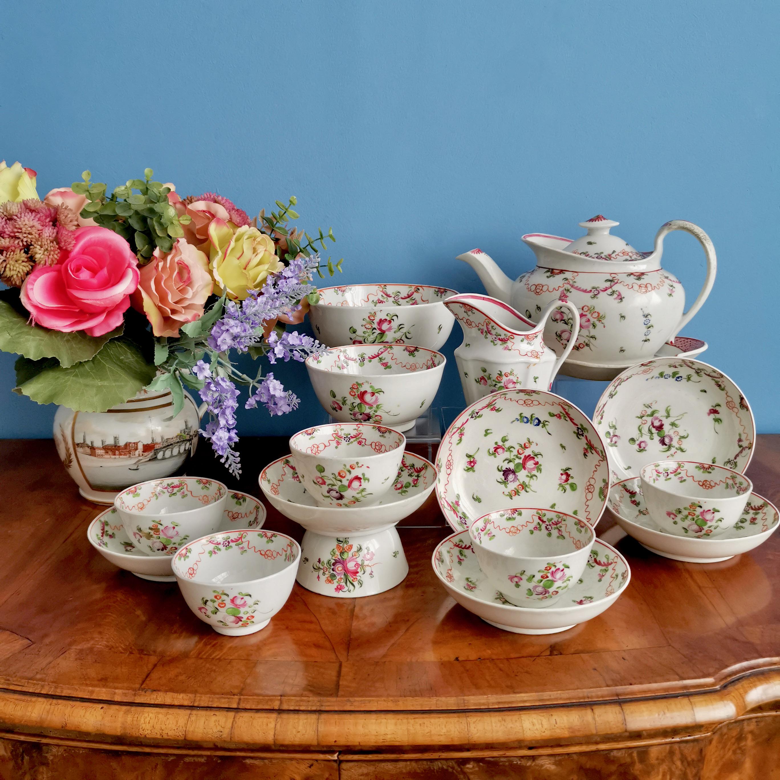 This is a beautiful and very charming tea service made by New Hall in circa 1795. Although the teapot is from a bit later (circa 1810). The service is made of hybrid hard paste porcelain and decorated in the famous 
