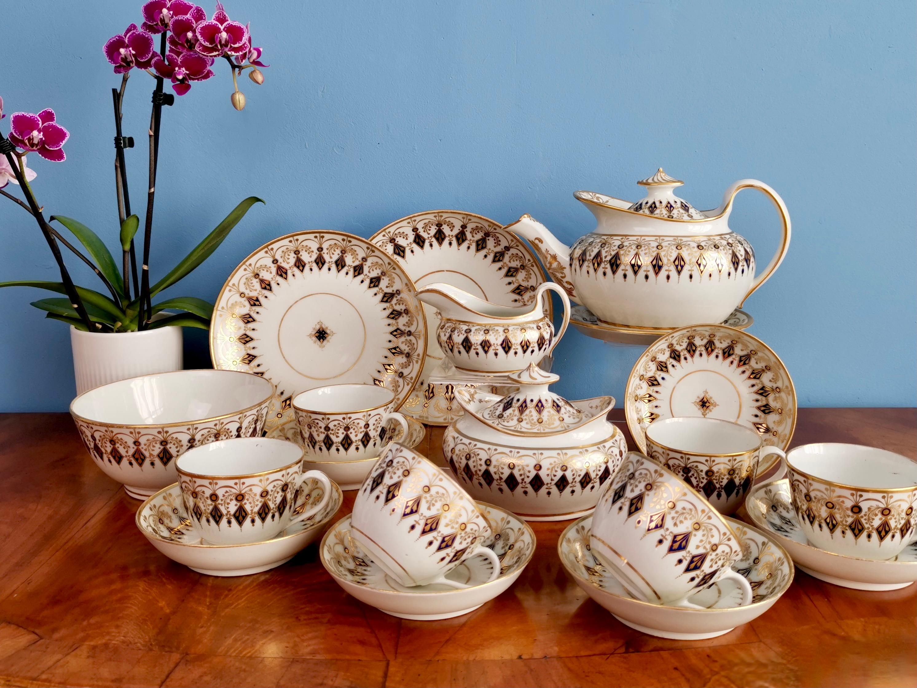 This is spectacular full tea service made by New Hall around the year 1810. The service consists of a lidded teapot on a stand, a lidded sucrier, a milk jug, six teacups and saucers, two large cake plates of slightly different sizes, and a slop