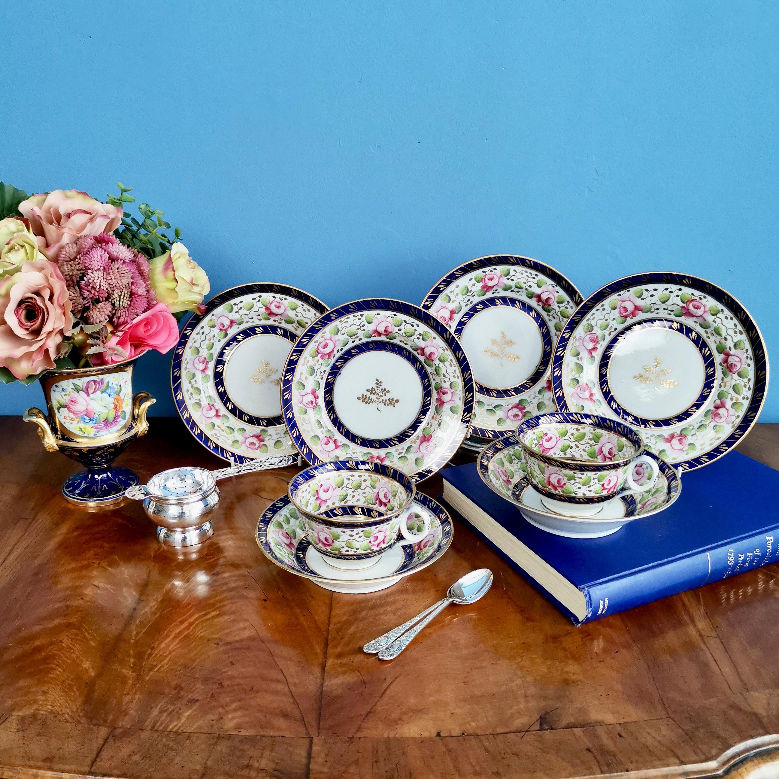 This is a set of four small tea plates with a charming pattern of roses set in a cobalt blue and gilt rim. They were made by New Hall circa 1815, which was known as the Regency era.

The New Hall factory started as a cooperative of several