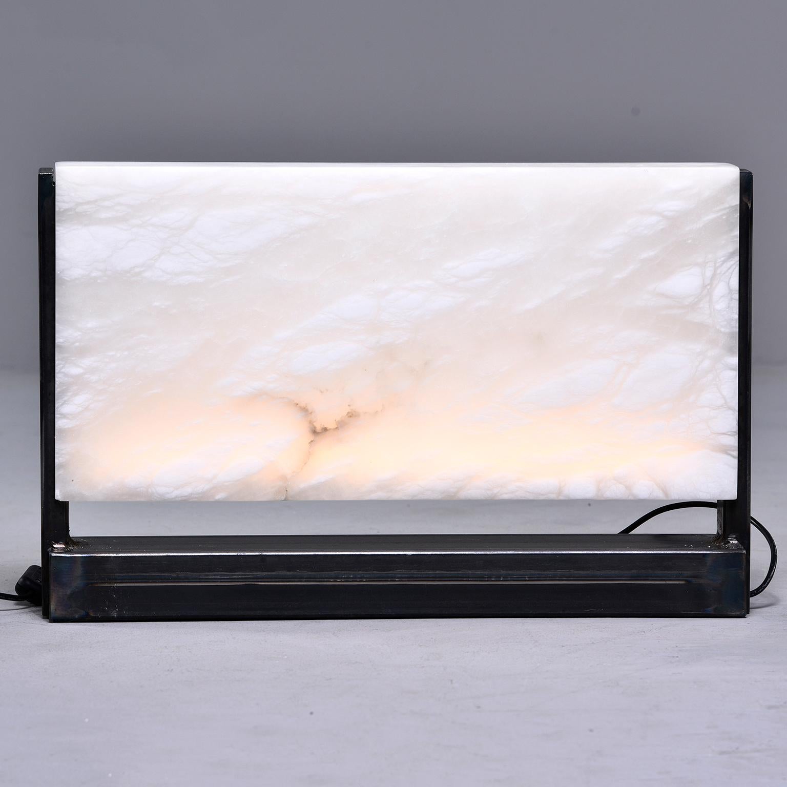 Custom made in Italy, this rectangular table lamp has a handcut white alabaster fitted shade with a black iron base. LED strip of lights inside base gives the alabaster a beautiful glow. Wired for US electrical standards. 