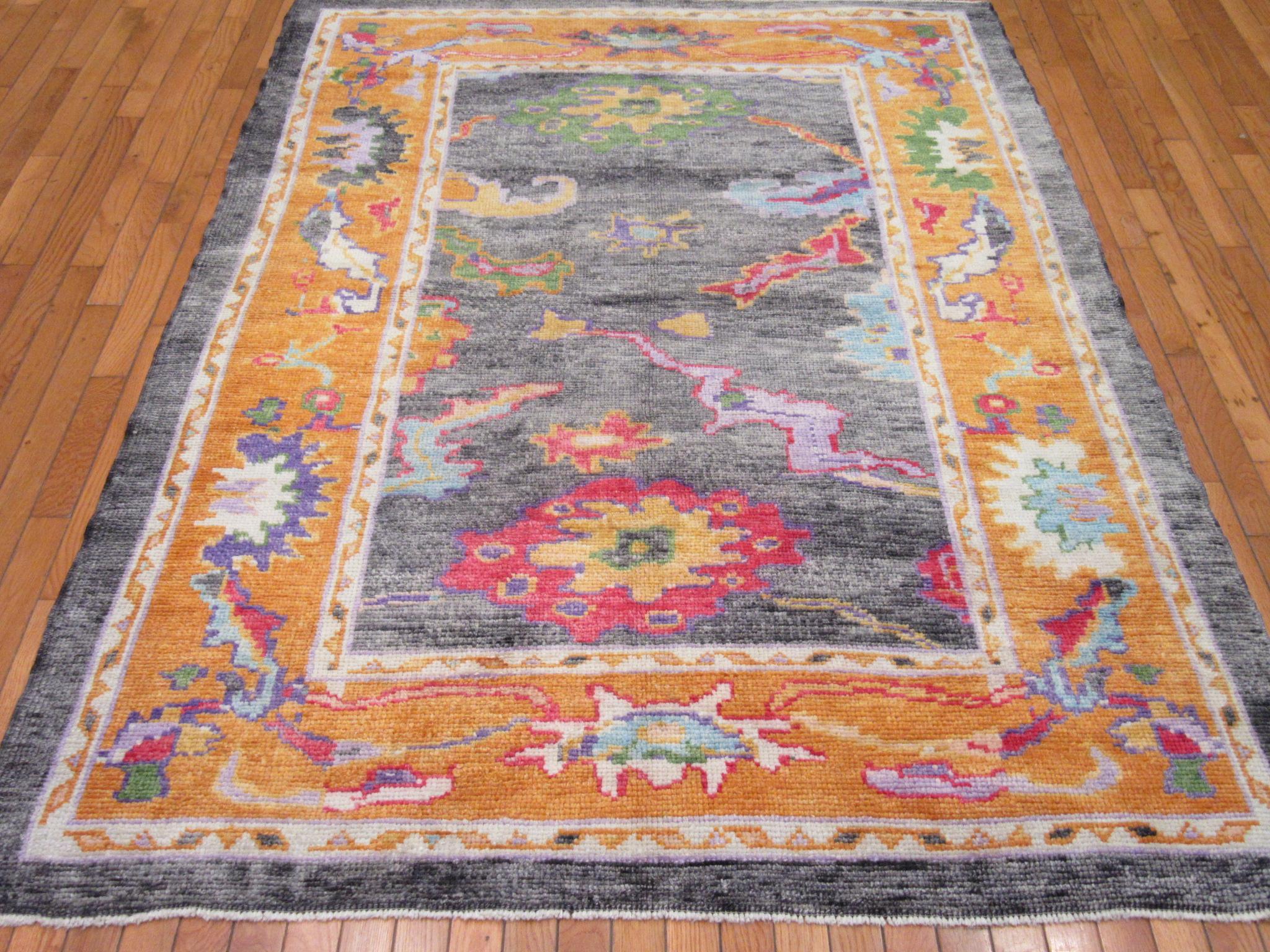 This is a small hand-knotted Oushak design rug from Turkey. It is made with fine Turkish wool colored with all natural dyes. It is a less formal rugs for any room. The rug measures 5' x 7'.