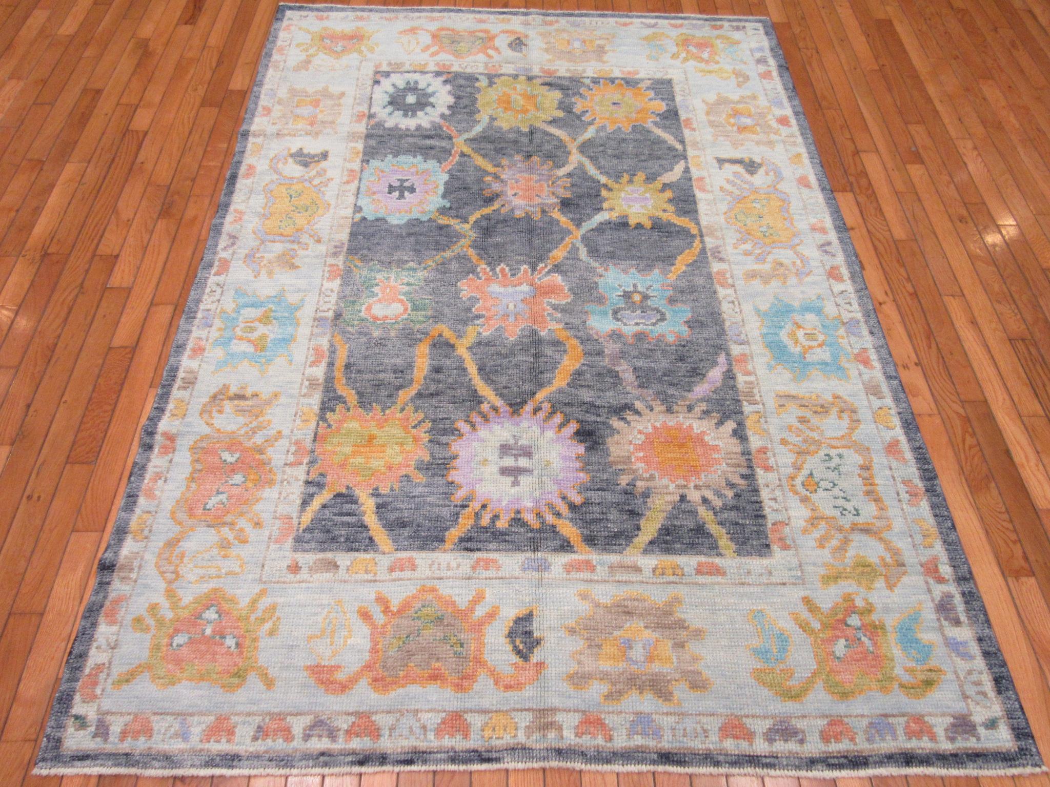 This is a new hand knotted Oushak rug from Turkey. It is made with all wool in rich colors. It has the regular nomadic Oushak weave and a old finish. The rug measures 5' 3