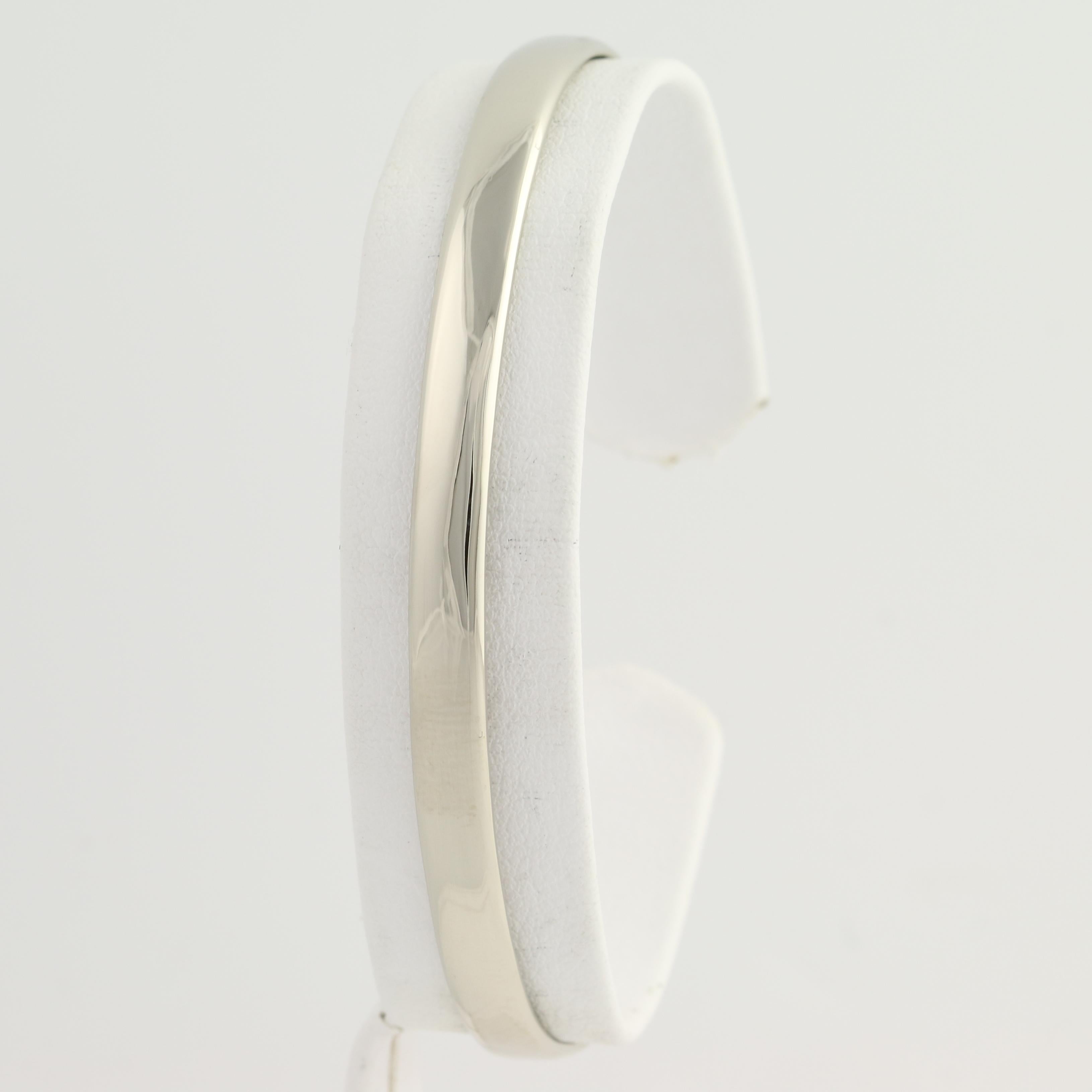 Treat yourself or a special friend to a chic, go-with-anything cuff bracelet! This brand-new piece is handmade from 14k white gold and the face is smoothly polished so that the cuff draws and reflects light with any movement. Solid in construction