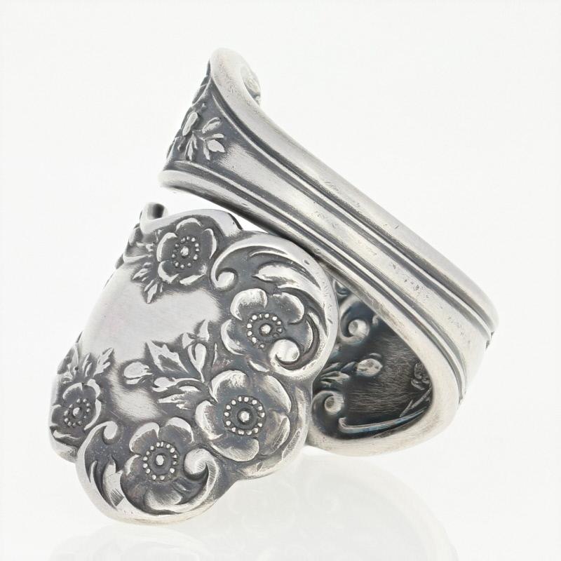 Featuring an antiqued finish, this handmade ring was created out of a spoon. 

This ring is a size 9 (manually adjustable).

Spoon Brand: Gorham
Spoon Pattern: Buttercup

Metal Content: Sterling Silver 

Style: Statement Bypass

Measurements
Face