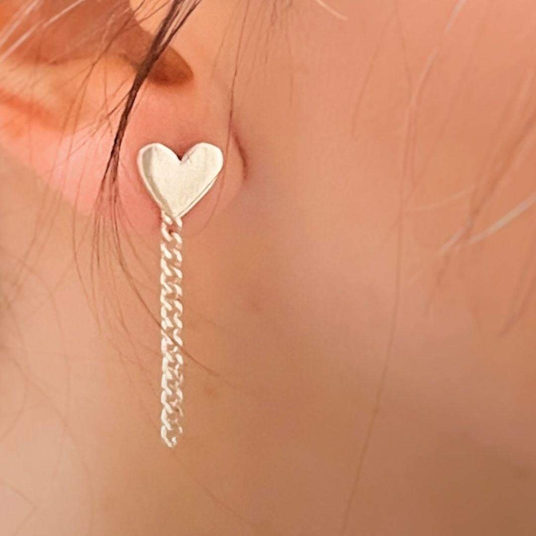 Add a touch of delicate elegance to your style with these handmade Heart Dangle Earrings, crafted in 925 sterling silver. Featuring a minimalist heart shape paired with a fine dangling chain, these earrings are the perfect blend of charm and