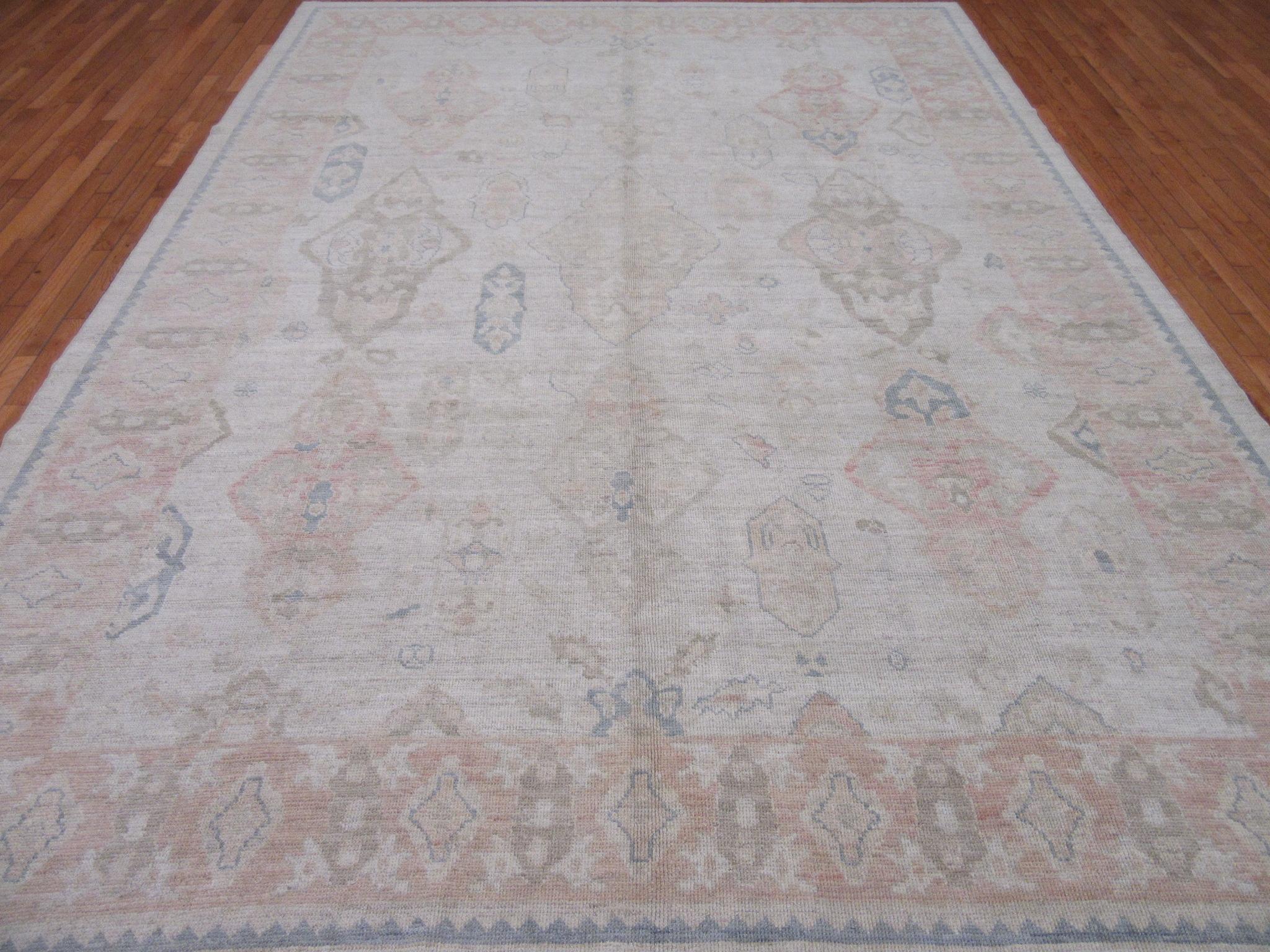 This is a new hand knotted Oushak design rug from Turkey. It is made with wool pile and wool on a wool foundation in soft tones. Its transitional all over pattern would make it a perfect choice for any room. The rug measures 9' 1” x 12' 6”.