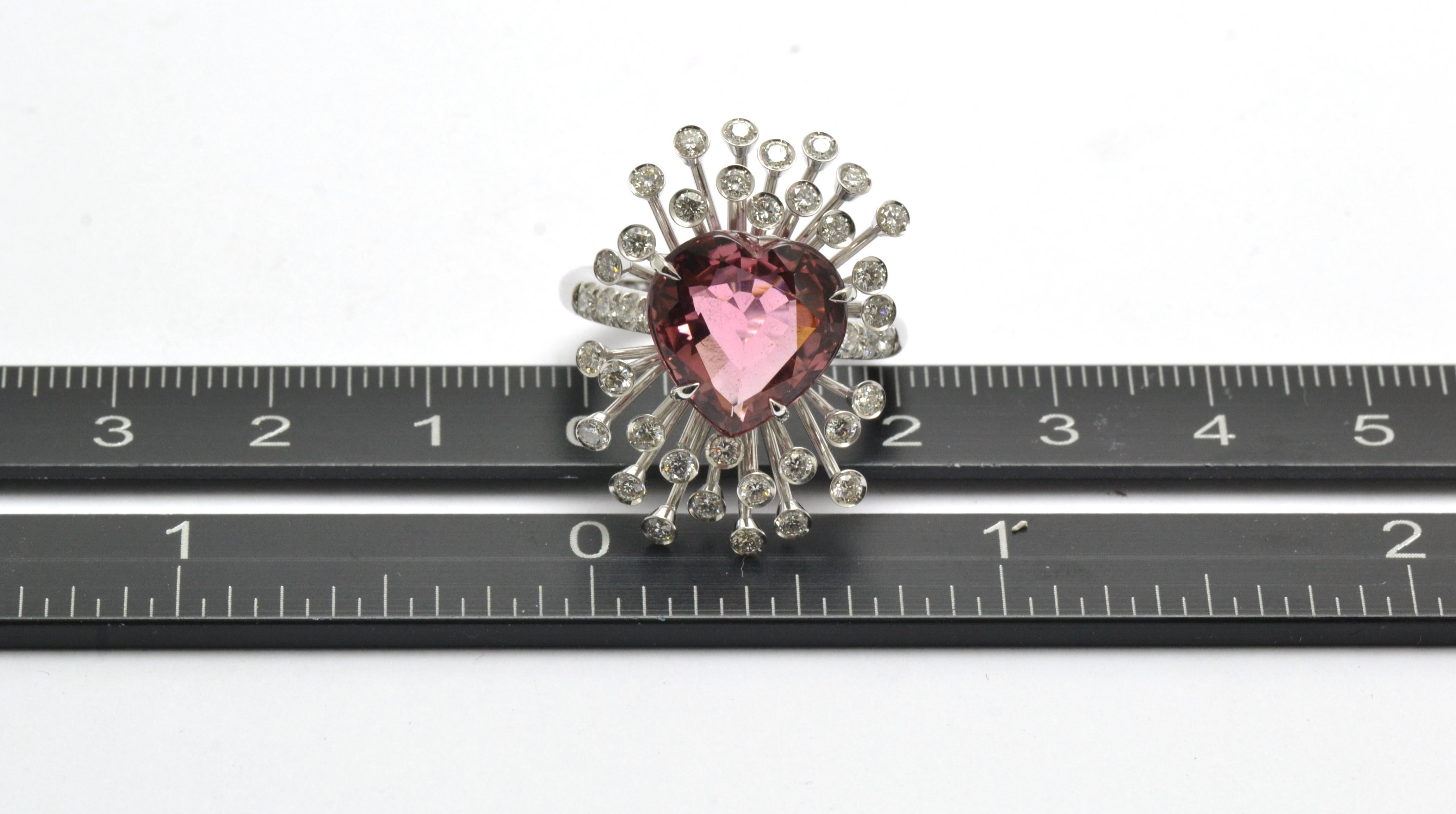 Stunning Spray design ring.  
The pavé diamond set band is supending a spray of diamonds highlighting the central pink tourmaline, heart cut.
Very suitable as engagement ring too.
We can size it and customize engraving a date or initials. 

18 KT
