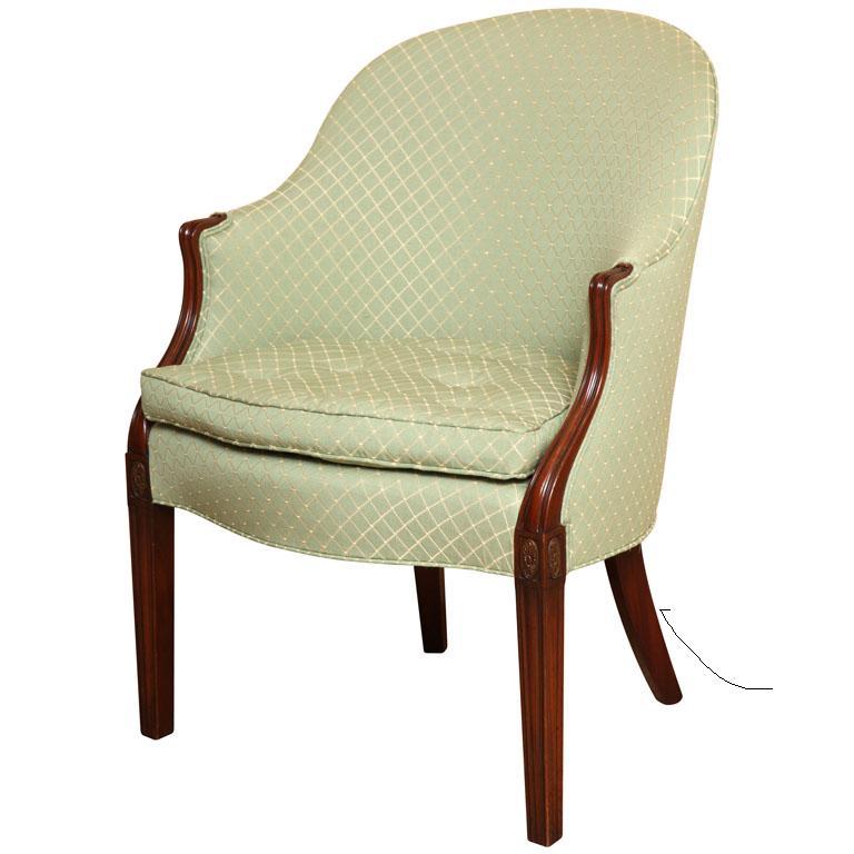 This NEW Wood & Hogan exquisite Hepplewhite Tub Chair is a masterpiece of refined design and unparalleled comfort. This chair boasts a distinctive silhouette with a gracefully curved back and a luxuriously down-buttoned seat cushion that beckons you