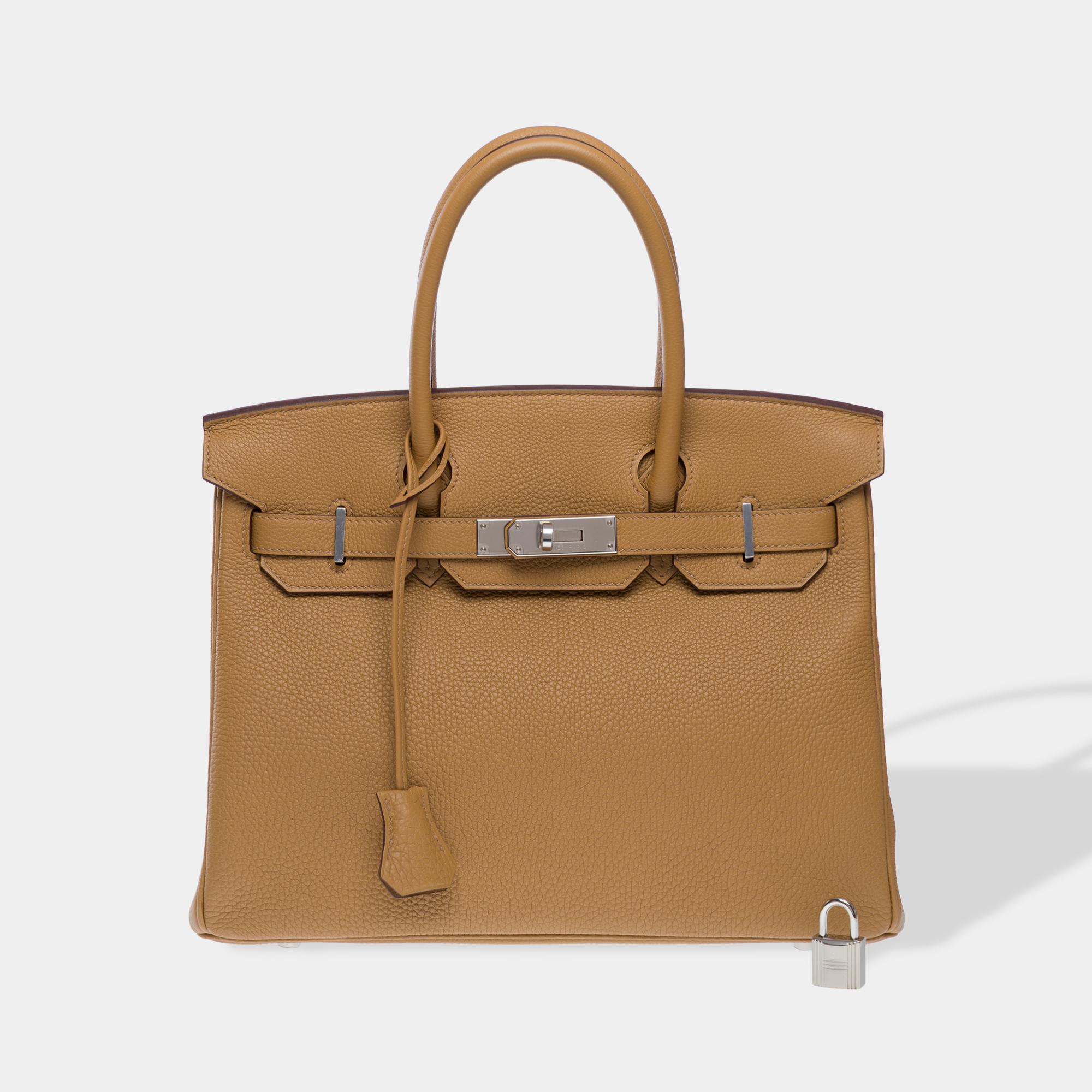Beautiful​ ​Hermes​ ​Birkin​ ​30​ ​handbag​ ​in​ ​Biscuit​ ​Togo​ ​calf​ ​leather,​ ​silver​ ​palladium​ ​metal​ ​trim,​ ​double​ ​brown​ ​leather​ ​handles​ ​for​ ​hand​ ​carry

Flap​ ​closure
Beige​ ​leather​ ​interior​ ​lining,​ ​one​ ​zip​