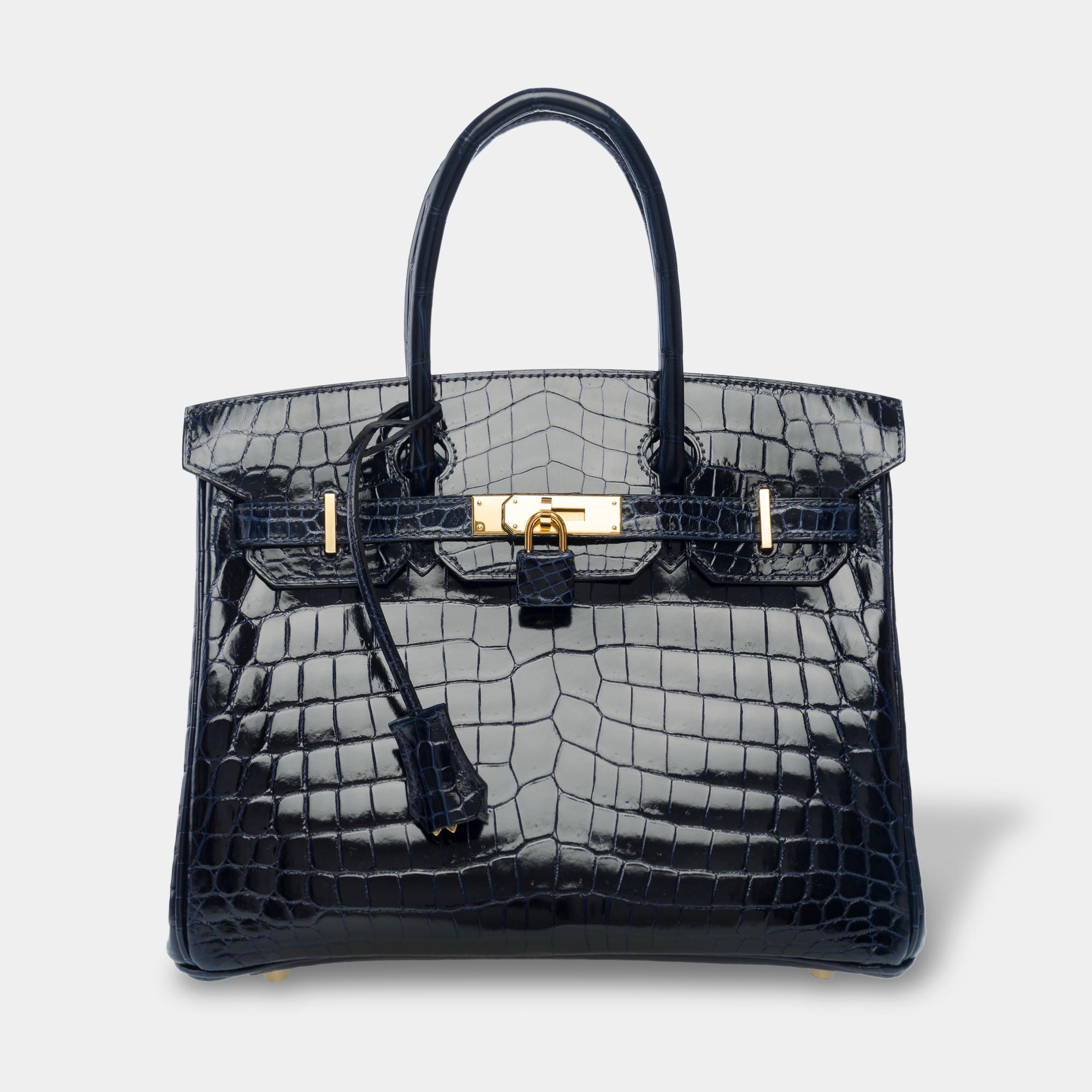 Amazing and Rare Hermes Birkin 30 handbag in shiny Navy Blue Niloticus Crocodile, gold plated metal trim, double handle in navy crocodile for a hand carry

Inner lining in blue leather, a zip pocket, a patch pocket  
Signature: 