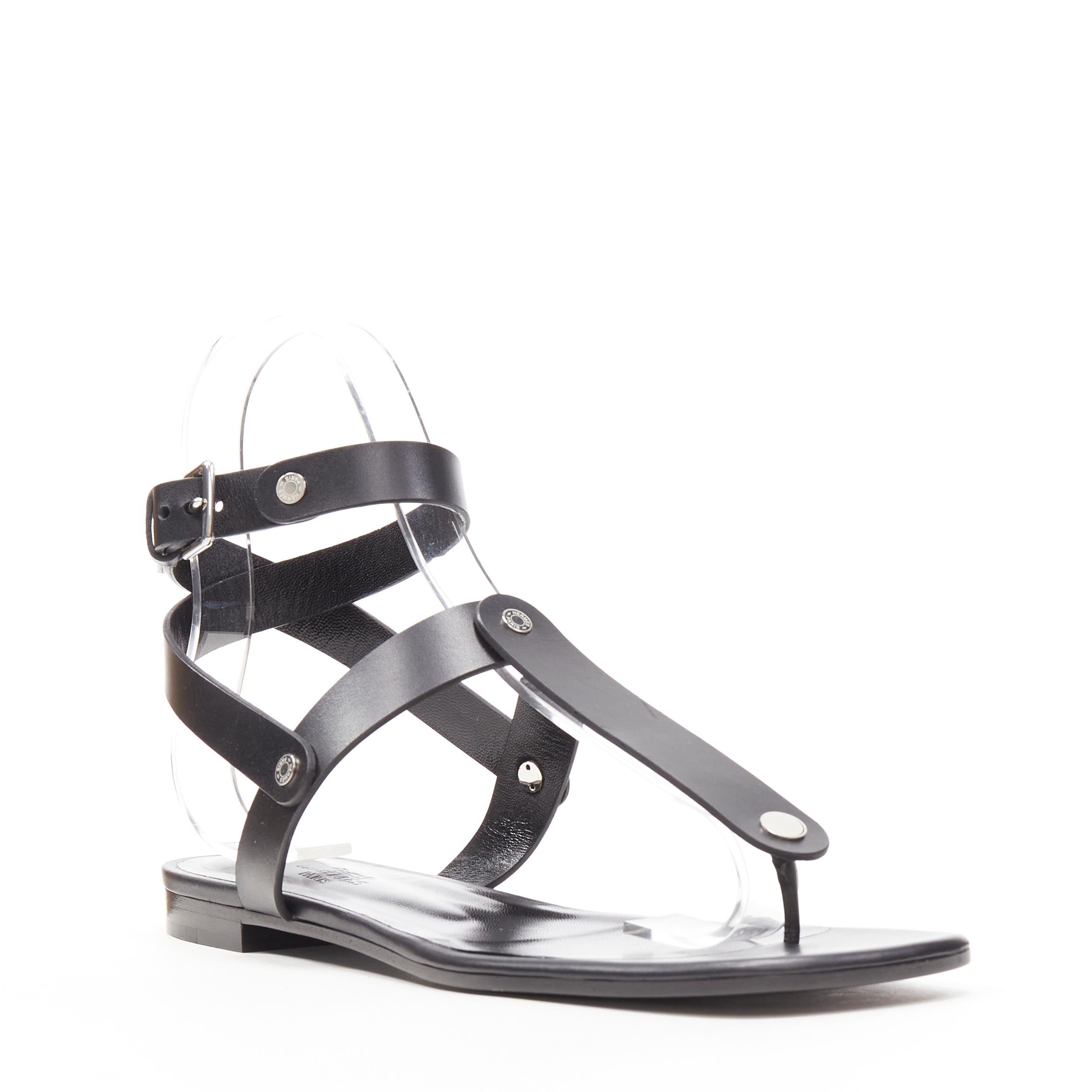 new HERMES black leather silver logo stud ankle strap thong sandals EU37.5 Reference: AEMA/A00016 
Brand: Hermes 
Model: T-strap gladiator 
Material: Leather 
Color: Black 
Pattern: Solid 
Closure: Buckle 
Extra Detail: Black leather. Silver-tone