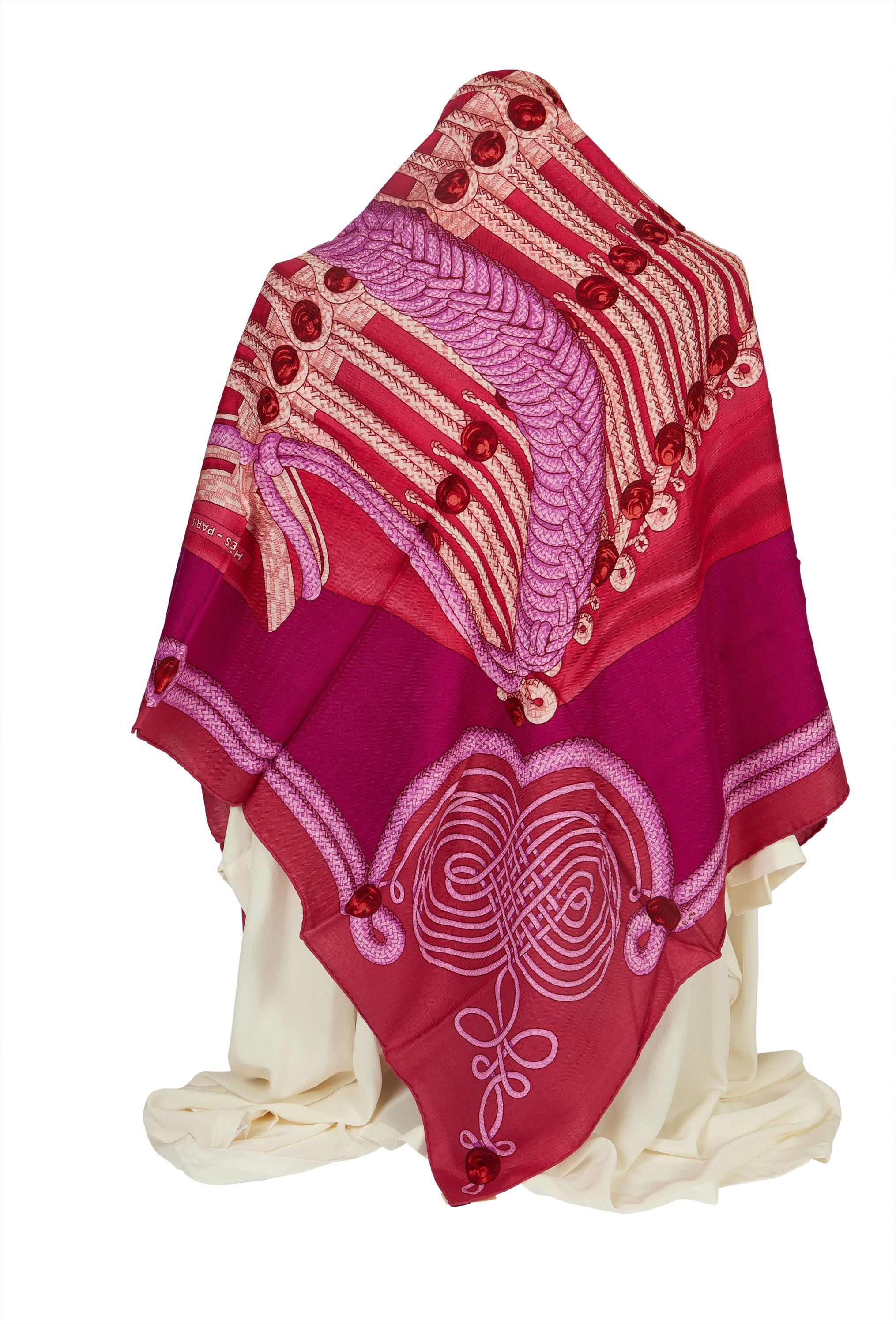 This Hermès Brandebourgs cashmere and silk shawl comes in a beautiful bright pink tone. It is in excellent condition and has no stains. This scarf is perfect for the winter as well for colder summer nights to have something over the shoulders.