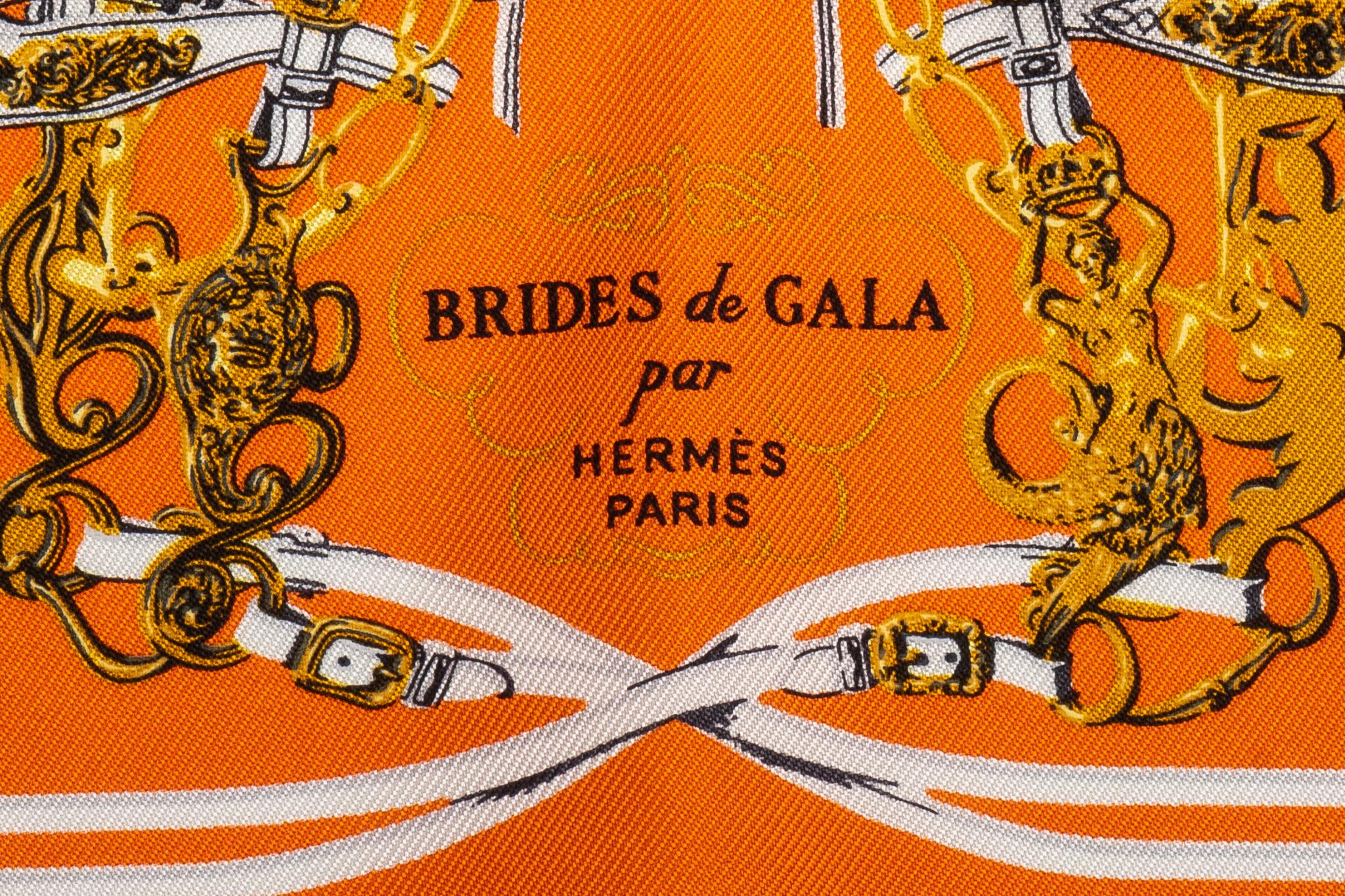 Hermès Brides de Gala pochette scarf by artist Hugo Grygkar. First issue date was 1957. Showcasing horse bits and pale blue trim. Hand-rolled edges. Comes in box.