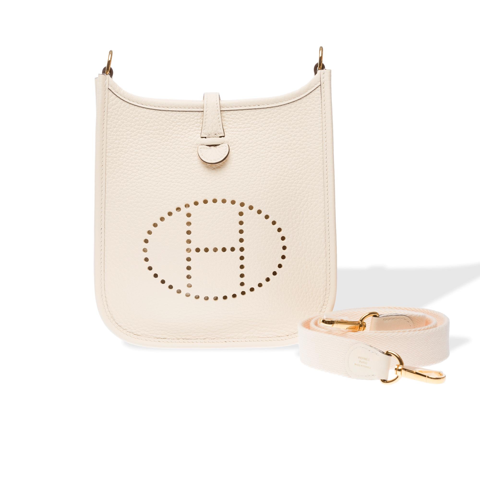 Splendid​​ ​​Hermes​​ ​​Evelyne​​ ​​16​​ ​​TPM​​ ​​Amazone​​ ​​crossbody​​ ​​bag​​ ​​in​​ ​​Nata​ ​​Taurillon​​ ​​Clémence​​ ​​leather,​​ ​​gold-tone​​ ​​metal​​ ​​hardware,​​ ​​a​​ ​​removable​​ ​​beige​ ​​canvas​​ ​​shoulder​​ ​​strap​​