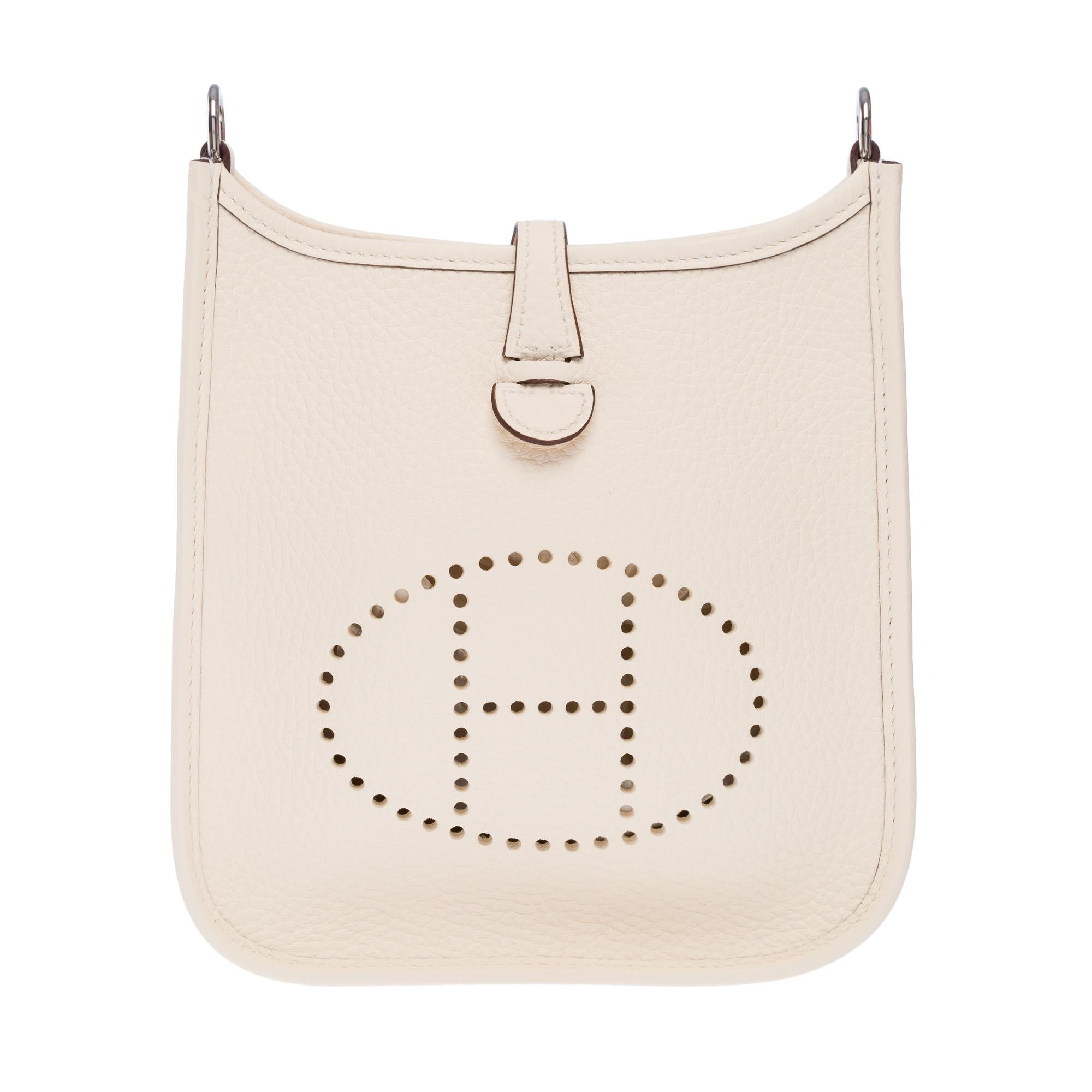 Splendid​​​ ​​​Hermes​​​ ​​​Evelyne​​​ ​​​16​​​ ​​​TPM​​​ ​​​crossbody​​​ ​​​bag​​​ ​​​in​​​ ​​​Nata​​ ​​​Taurillon​​​ ​​​Clémence​​​ ​​​leather,​​​ ​​​silver-tone​​​ ​​​metal​​​ ​​​hardware,​​​ ​​​a​​​ ​​​removable​​​ ​​​beige​​ ​​​canvas​​​