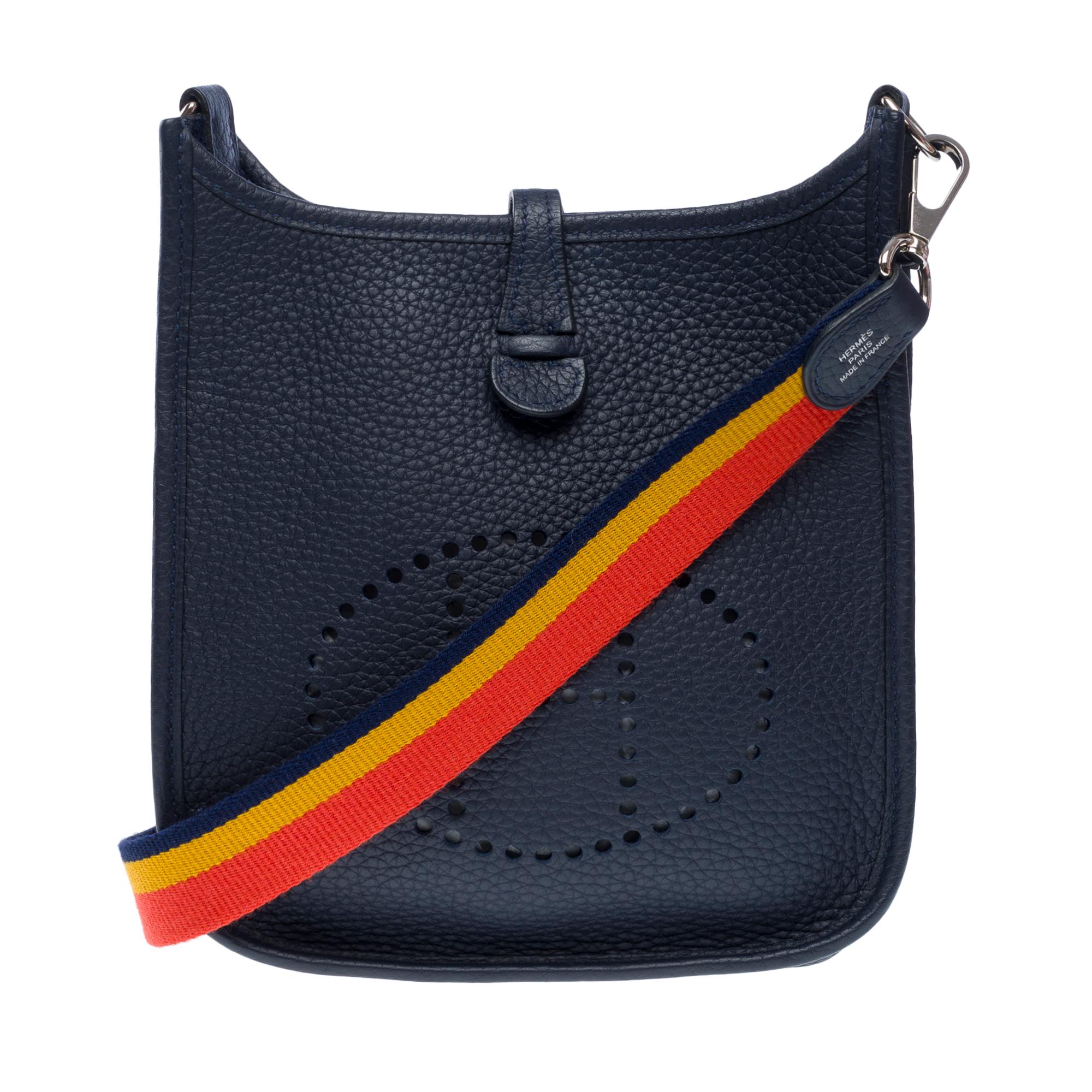 Beautiful​ ​Hermes​ ​Evelyne​ ​16​ ​TPM​ ​shoulder​ ​bag​ ​in​ ​Taurillon​ ​Clémence​ ​Blue​ ​nuit​ ​leather,​ ​silver​ ​metal​ ​trim,​ ​a​ ​removable​ ​Woody​ ​multicolor​ ​canvas​ ​shoulder​ ​strap​ ​allowing​ ​for​ ​shoulder​ ​or​ ​crossbody​