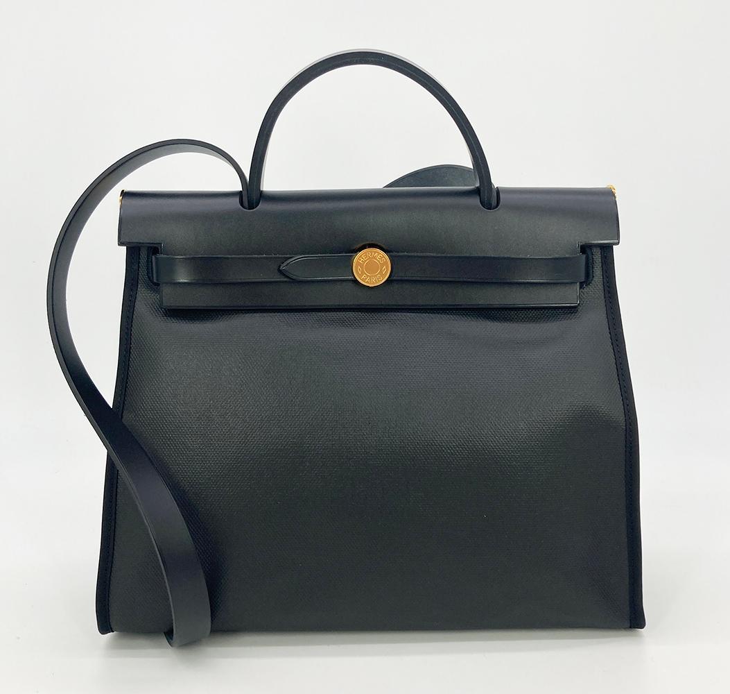 Hermès Herbag Zip PM 31 Toile H Berline Vache Hunter Black Ecru in new unused condition. Black vache hunter leather and waterproof coated canvas exterior trimmed with rare gold hardware and back toile canvas zip pocket. Top herbag double strap flap