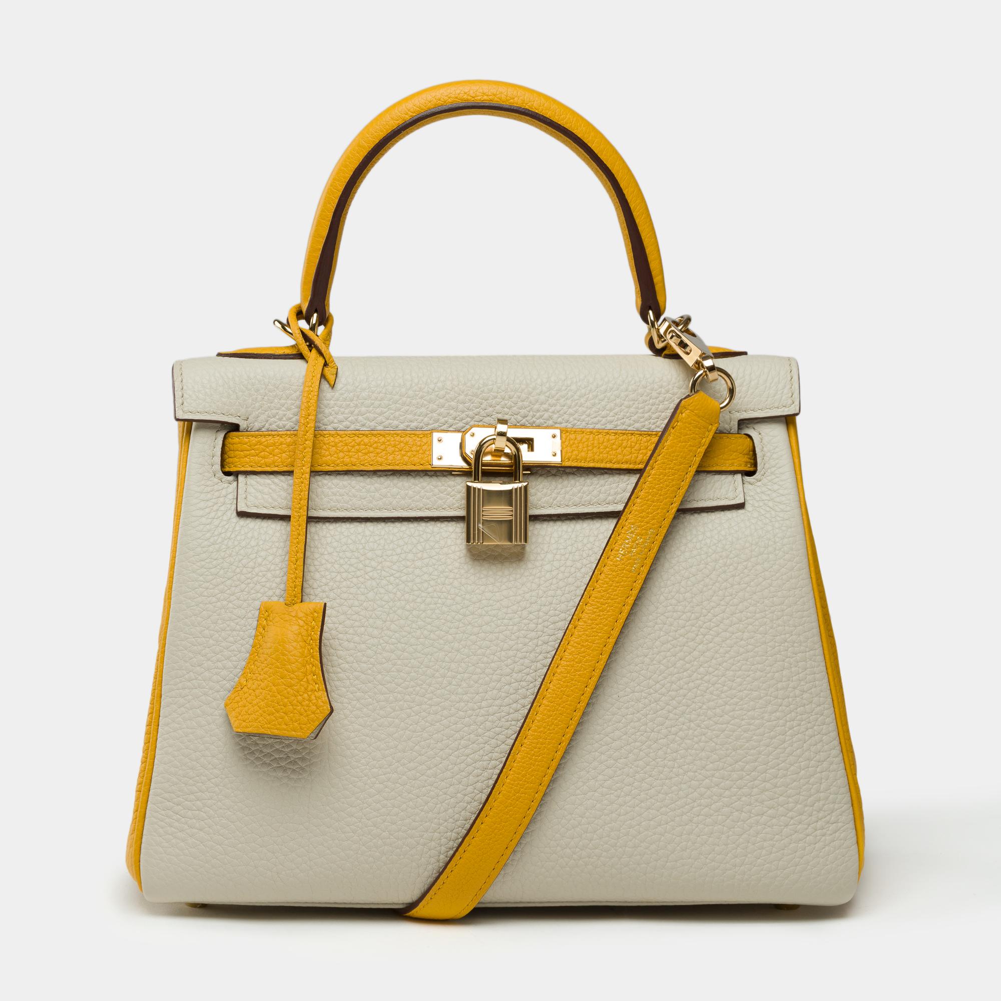 Exceptional​ ​and​ ​extremely​ ​rare​ ​Hermes​ ​Kelly​ ​25​ ​Retourne​ ​bicolor​ ​handbag​ ​strap​ ​special​ ​order​ ​(HSS),​ ​in​ ​Craie​ ​and​ ​Jaune​ ​Soufre​ ​Togo​ ​leather,​ ​with​ ​gold-plated​ ​hardware,​ ​single​ ​handle​ ​in​ ​yellow​