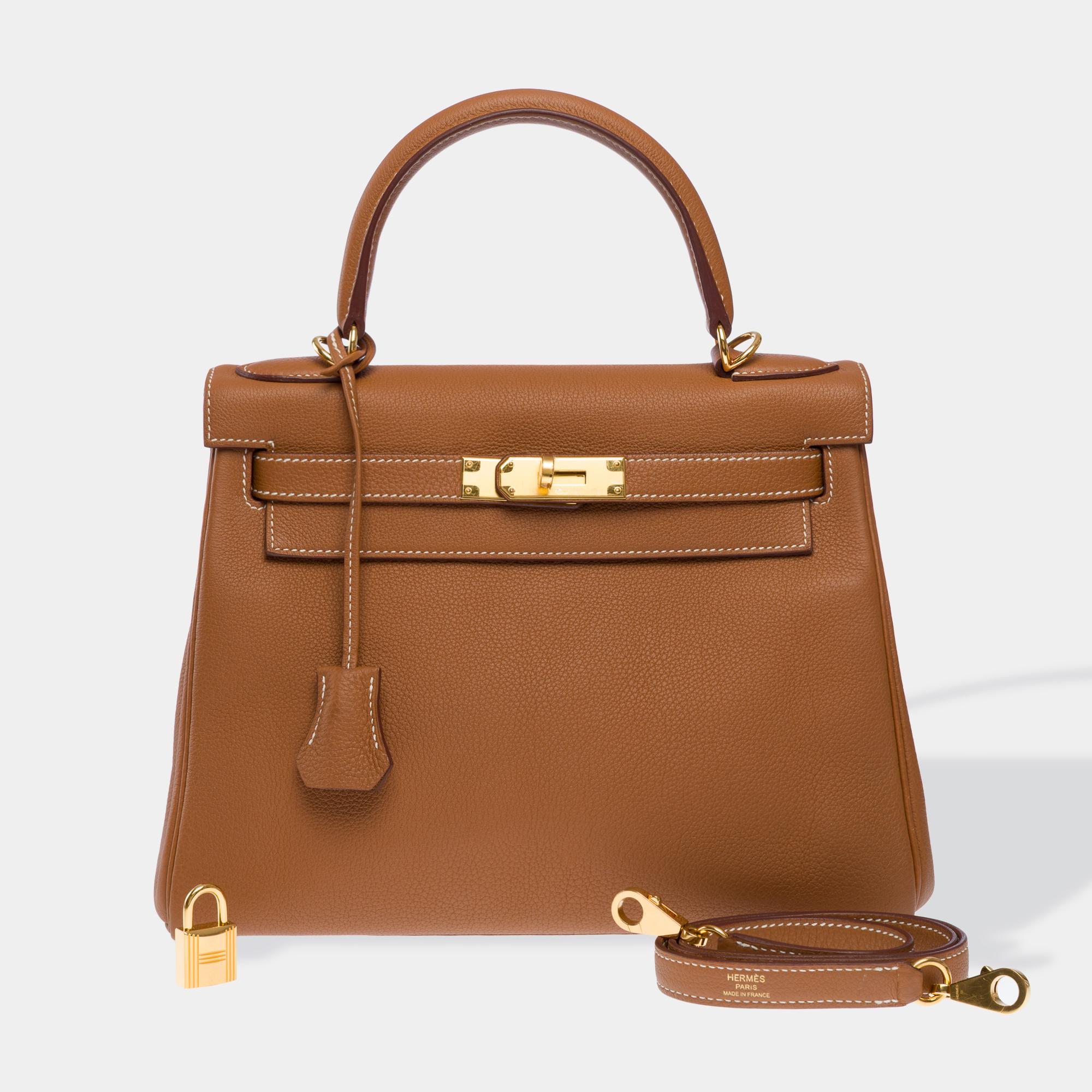 Magnificent​ ​Hermès​ ​Kelly​ ​28​ ​handbag​ ​with​ ​gold​ ​Togo​ ​leather​ ​shoulder​ ​strap,​ ​gold​ ​metal​ ​hardware,​ ​single​ ​brown​ ​leather​ ​handle,​ ​removable​ ​gold​ ​leather​ ​shoulder​ ​strap​ ​allowing​ ​it​ ​to​ ​be​ ​carried​ ​by​