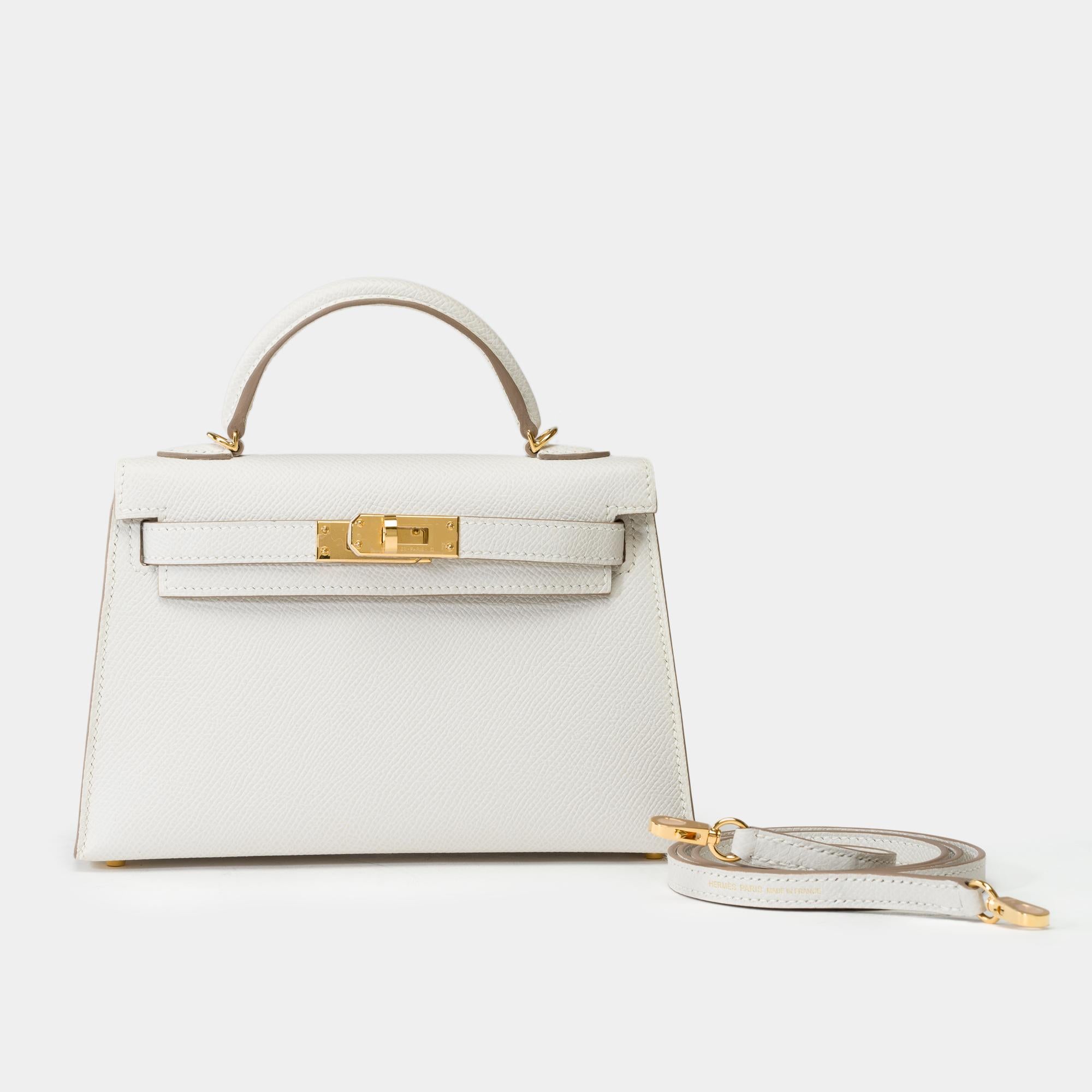 Exceptional​ ​Hermès​ ​Mini​ ​Kelly​ ​20​ ​cm​ ​handbag​ ​in​ ​Gris​ ​Pale​ ​Epsom​ ​calfskin,​ ​with​ ​gold-plated​ ​metal​ ​hardware,​ ​gray​ ​leather​ ​handle,​ ​and​ ​gray​ ​leather​ ​shoulder​ ​strap​ ​allowing​ ​a​ ​hand​ ​or​ ​shoulder​ ​or​