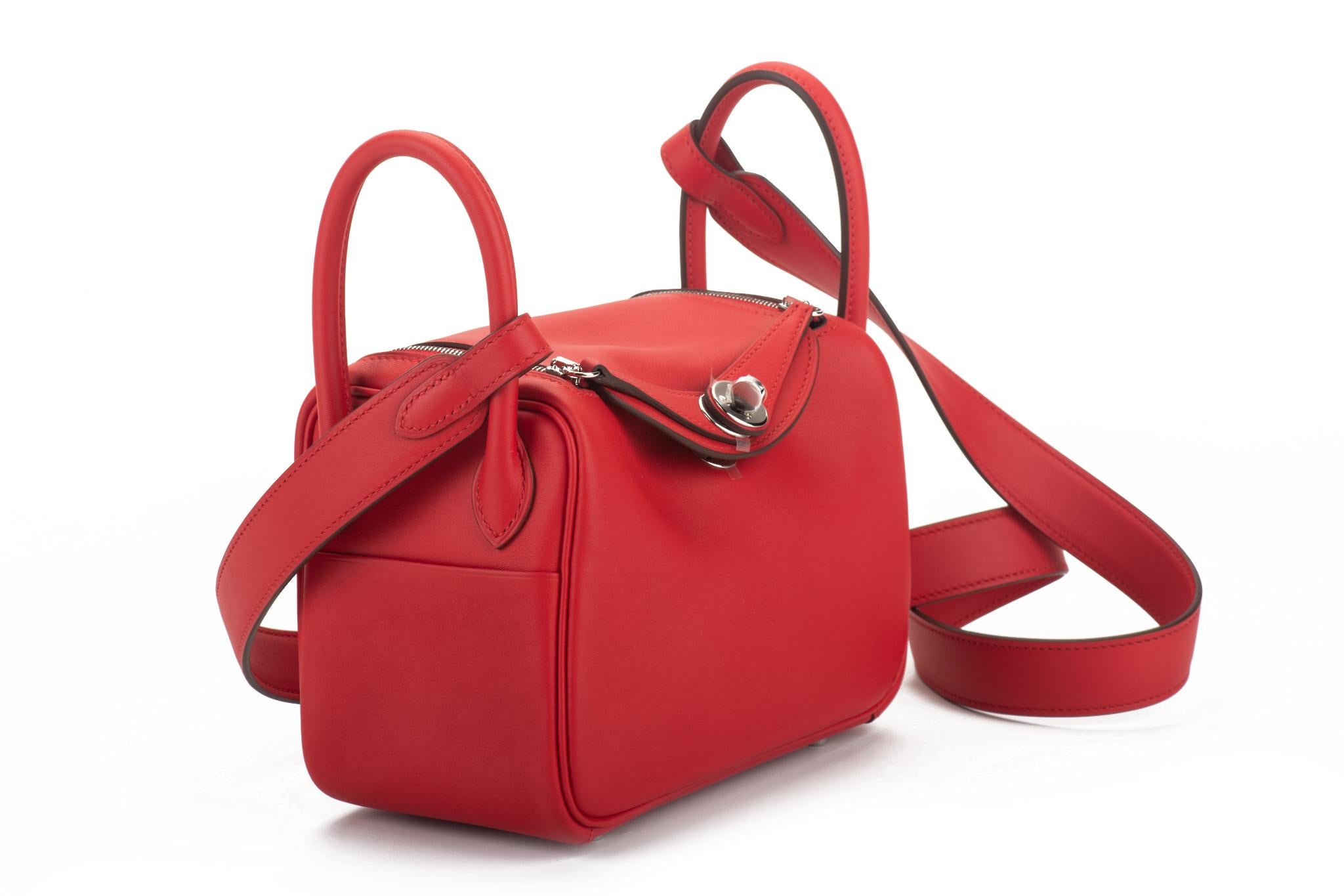 Hermes brand new in box mini lindy verso rouge de coeur et rouge pilent swift with palladium hardware. Date stamp Z, 2021. Coveted new size , can be worn in three ways, also cross body. Two interior pockets. Comes with dust cover and original box.