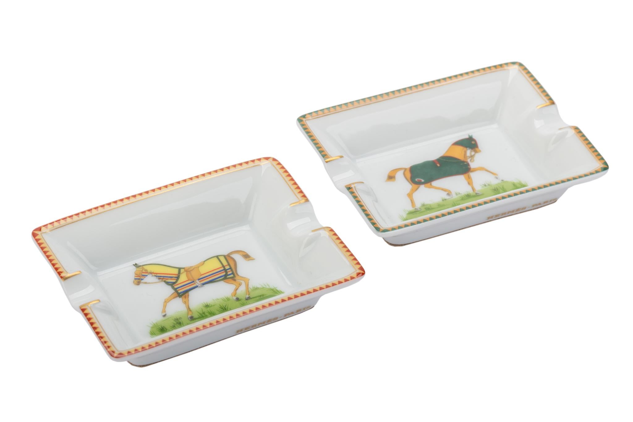 Hermes brand new in box pair of small porcelain ashtrays with horse design. Come with original box.