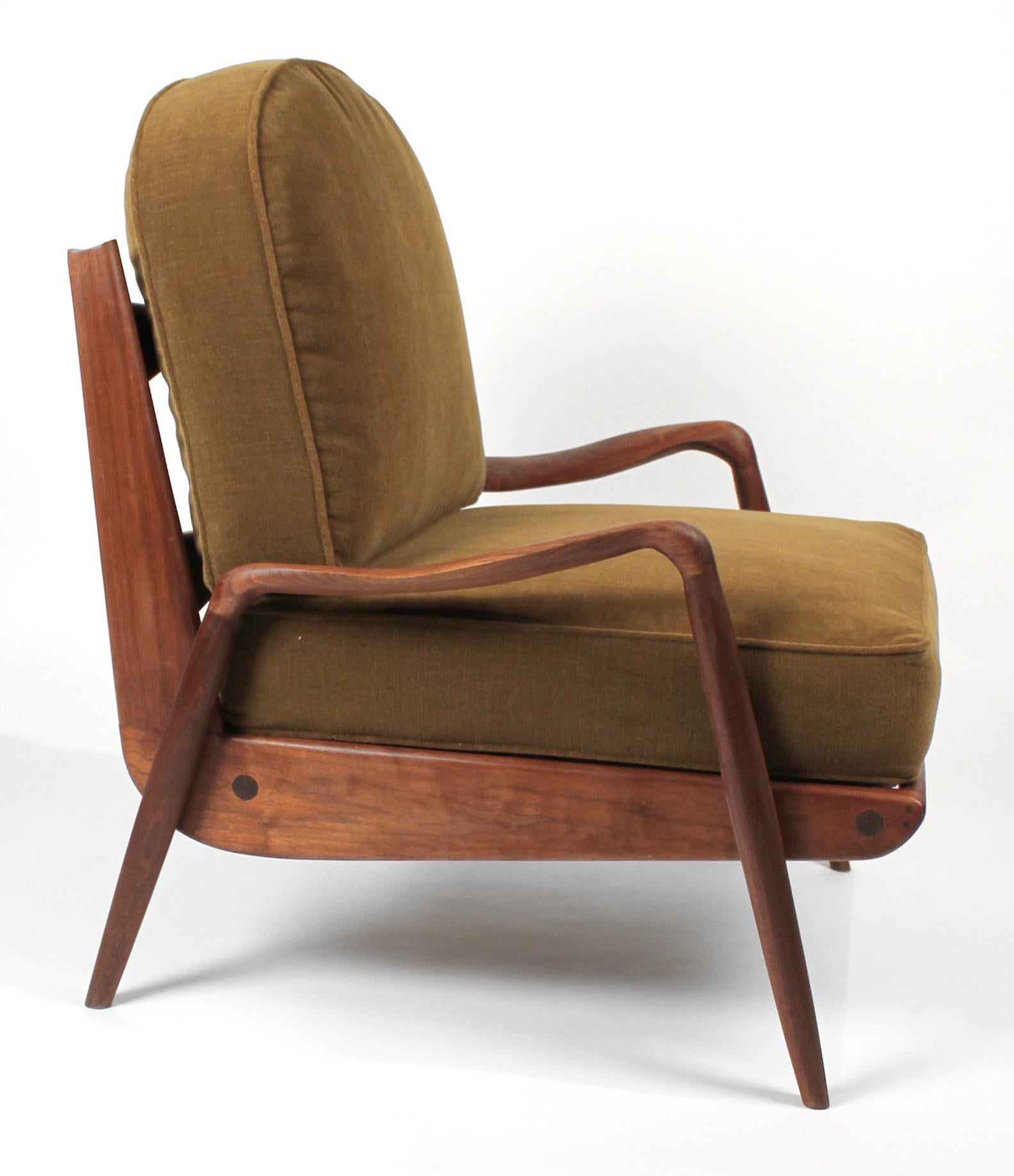 One of the last few chairs produced by Phillip Lloyd Powell in his New Hope Studio before he passed. This example is well crafted and has beautiful graining to the wood. The foam is new and the velvet upholstery is very complementary to the frame.