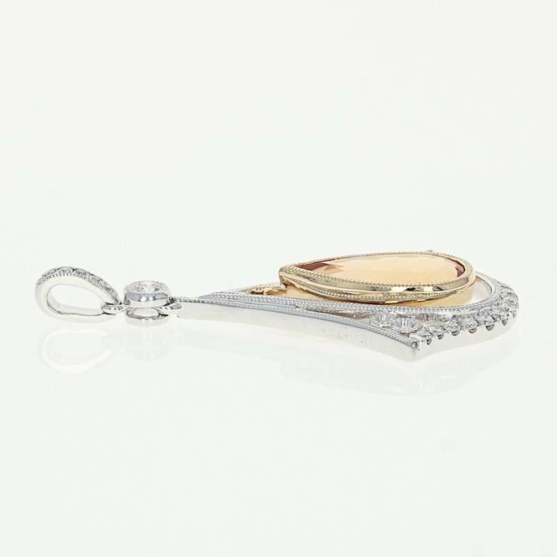 Old world enchantment! Composed of 14k white and yellow gold, this gorgeous NEW piece is fashioned in a timeless drop design showcasing an Imperial topaz solitaire beautifully accompanied by a sparkling array of diamond accents with milgrain details