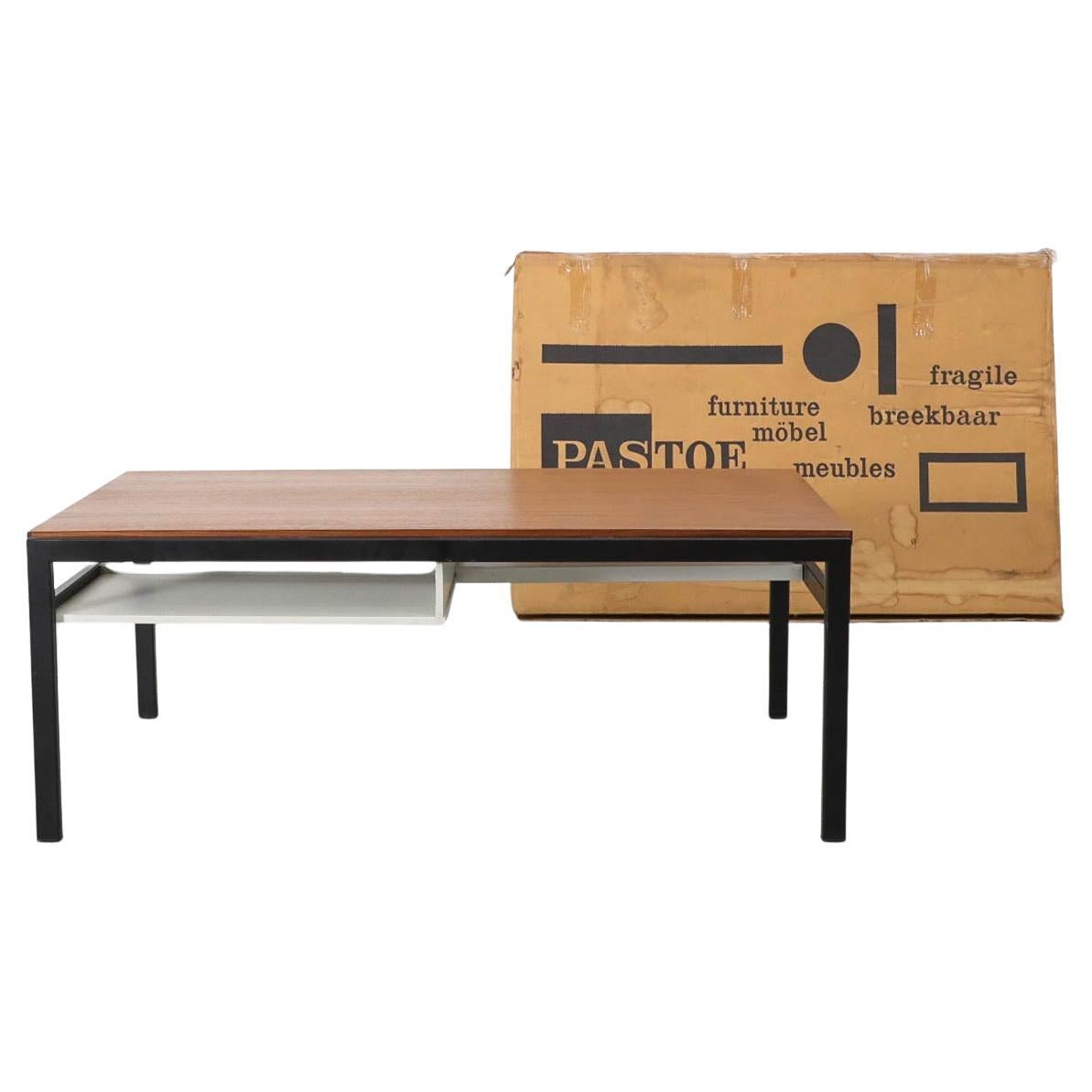 From the family that originally owned it comes this 1958 TU04 Cees Braakman Modernist coffee table with black enameled metal frame and reversible top in teak and white Formica with lower white wooden lacquered cubbies. There is some minimal wear to