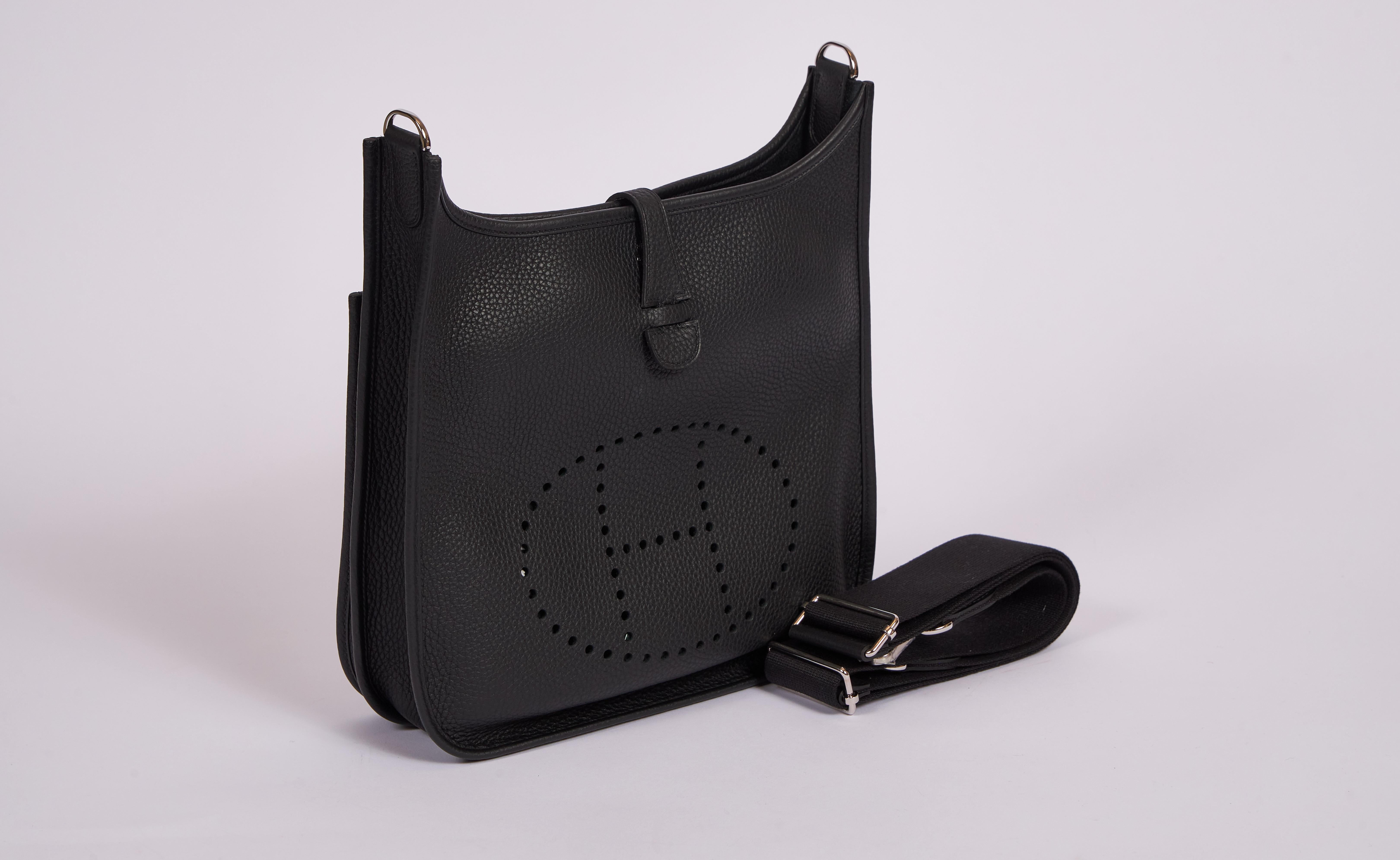 Hermès brand new in box medium (PM) Evelyne in black clemence leather with palladium hardware. Adjustable shoulder strap; can be worn crossbody. Date stamp C for 2018. Comes with strap duster, large dust cover and original box.