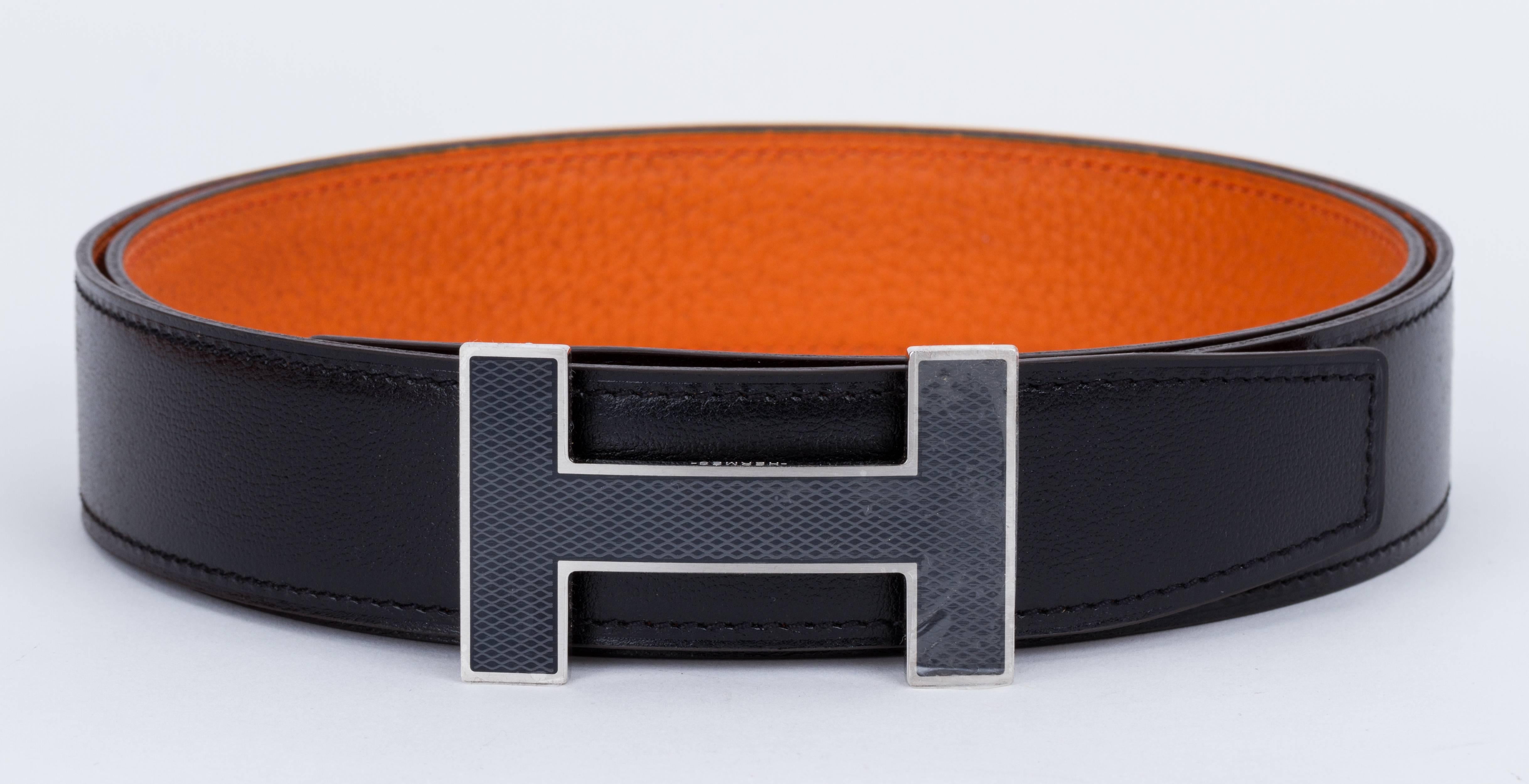 Hermes BNIB reversible unisex H belt, black box calf leather and orange togo. Black enamel and palladium H buckle. Date stamp A for 2017. European size 95. Comes with dust cover, box, ribbon and dust bag.
