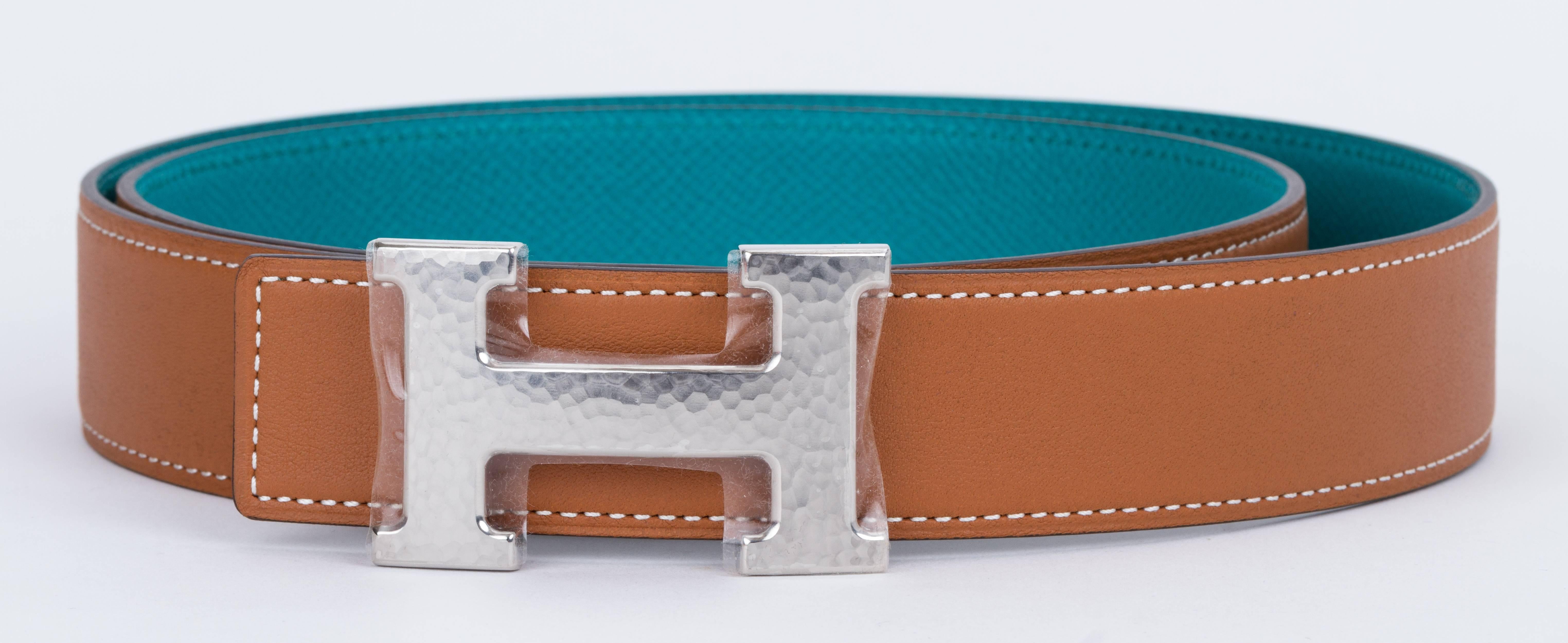 Hermes brand new in box reversible unisex h belt. Gold swift leather and blue pain epsom leather, Palladium hammered buckle. European size 95cm. Date stamp X for 2016. Comes with dust cover, box, ribbon and shopping bag.