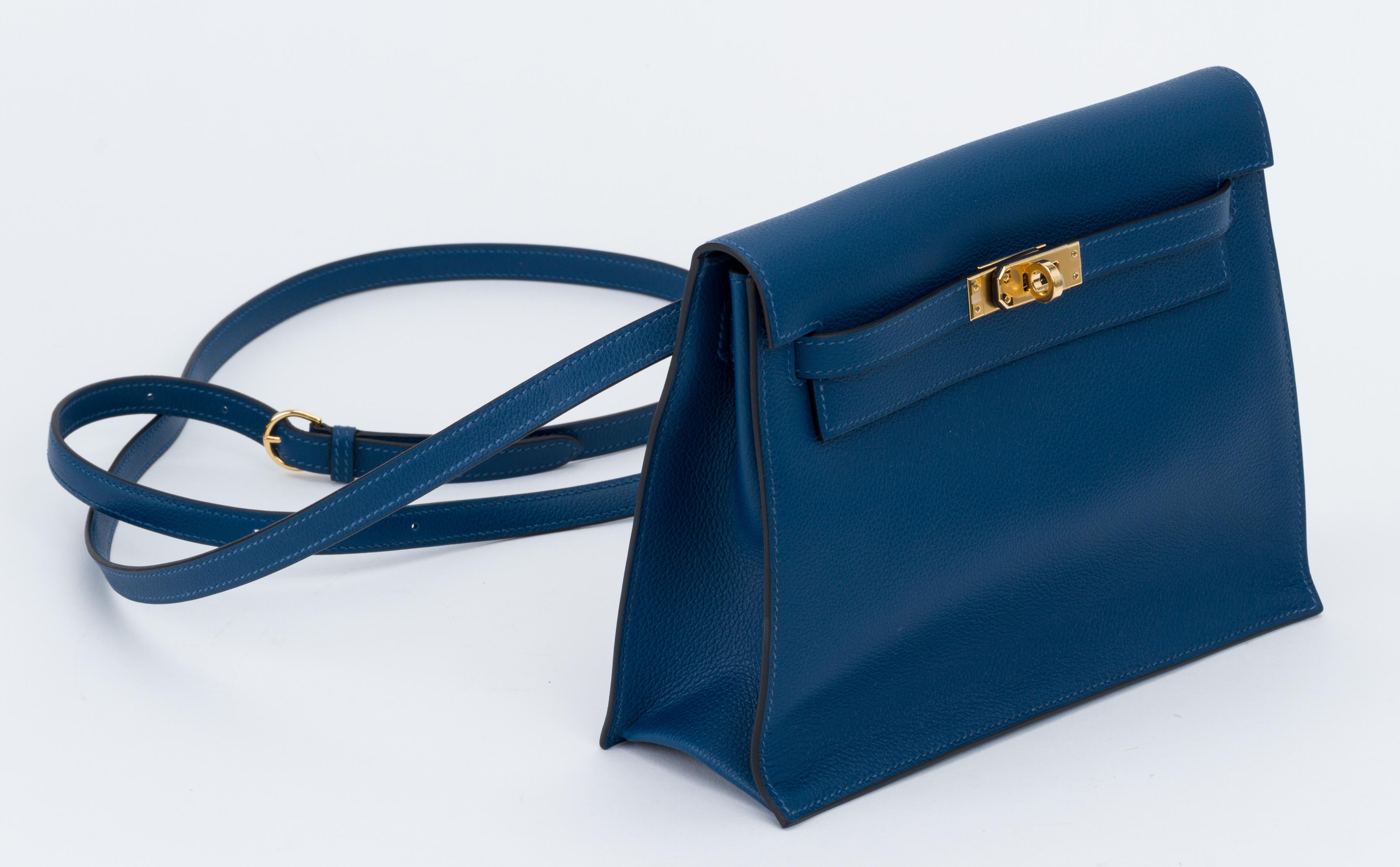 Hermes brand new in box deep blue evercolor kelly danse with gold tone hardware.
The best and newest reissue of the Hermes collection, can be worn as a fanny pack, a clutch or a cross body. Blind stamp Y for 2020. Comes with booklet, felt, blacked