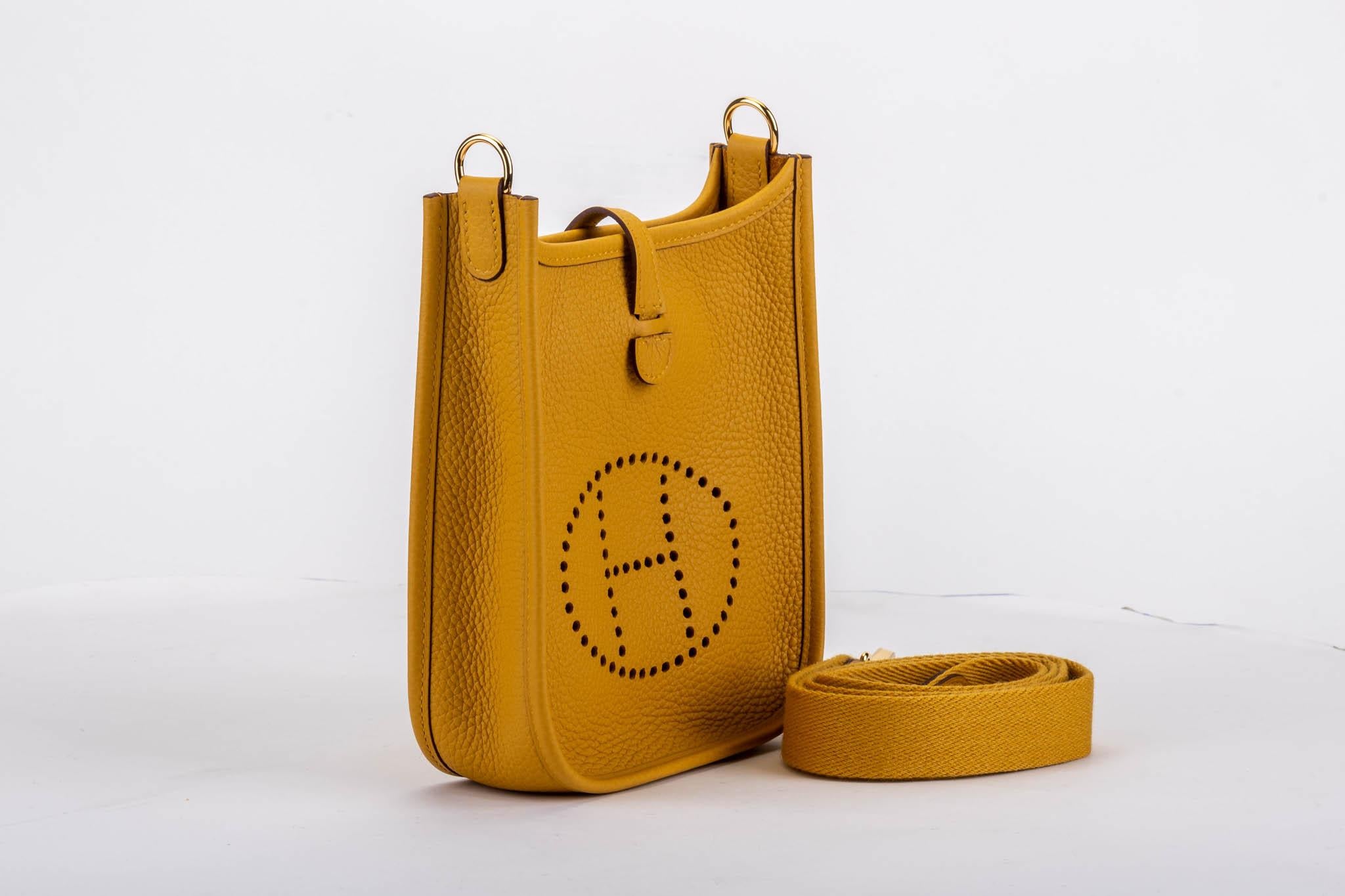 Hermès mini Evelyne bag in jaune ambre clemence leather with gold tone hardware. Shoulder drop, 22.5