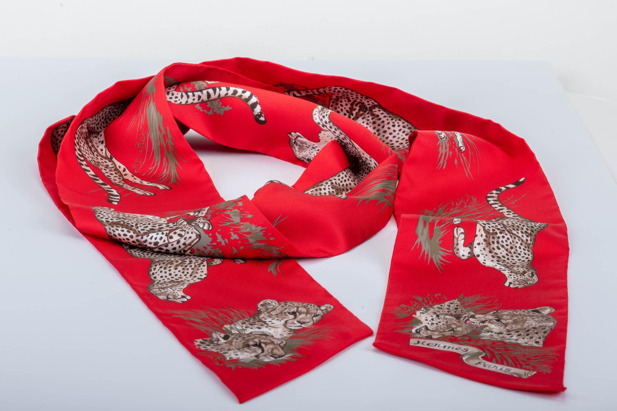 New in Box Hermes red guepards thin maxi twilly. 100% silk, comes with original orange box and instructions booklet.
