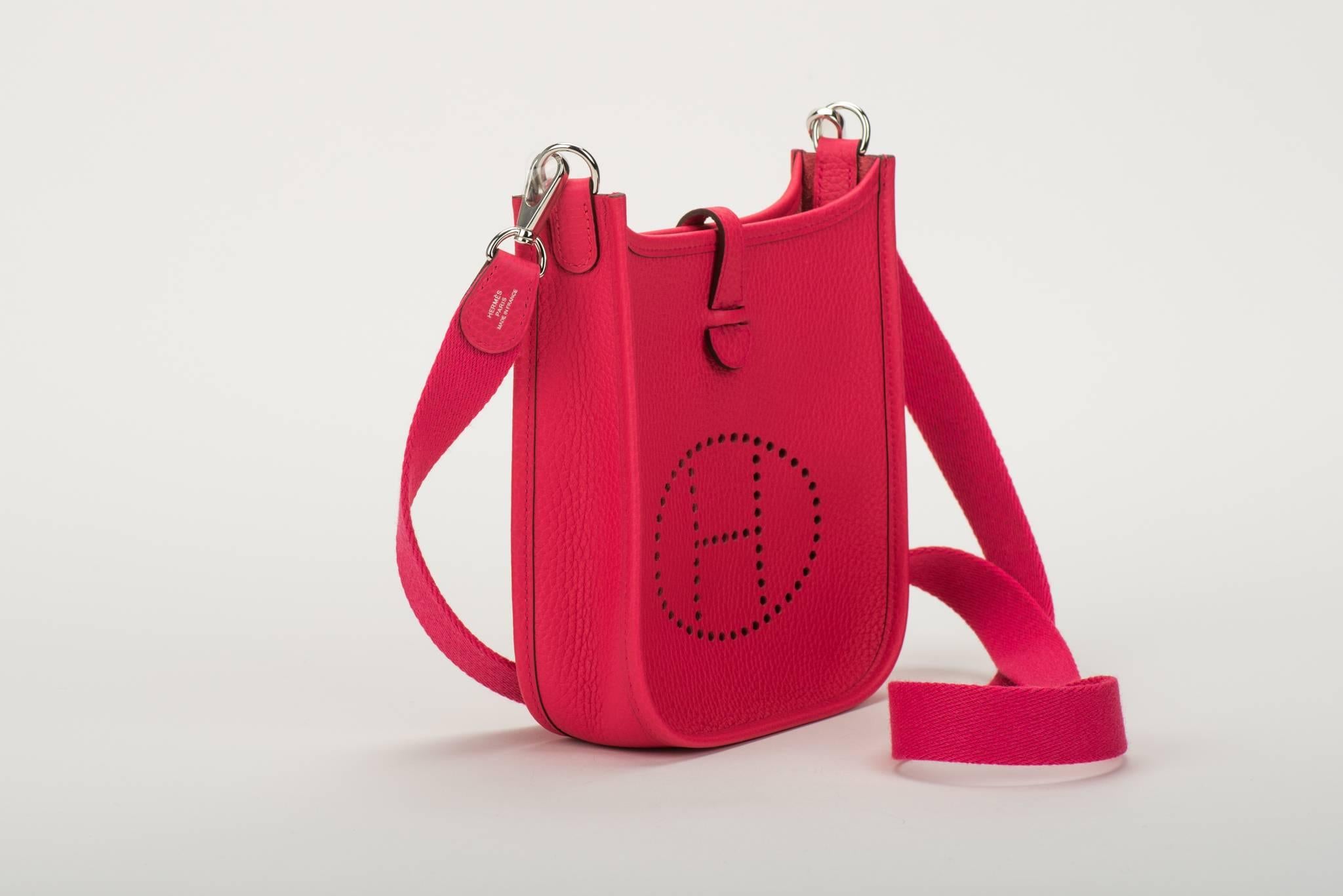 Hermès mini Evelyne shoulder bag in electric rose extreme clemence leather with palladium hardware. Never used. Dated 
