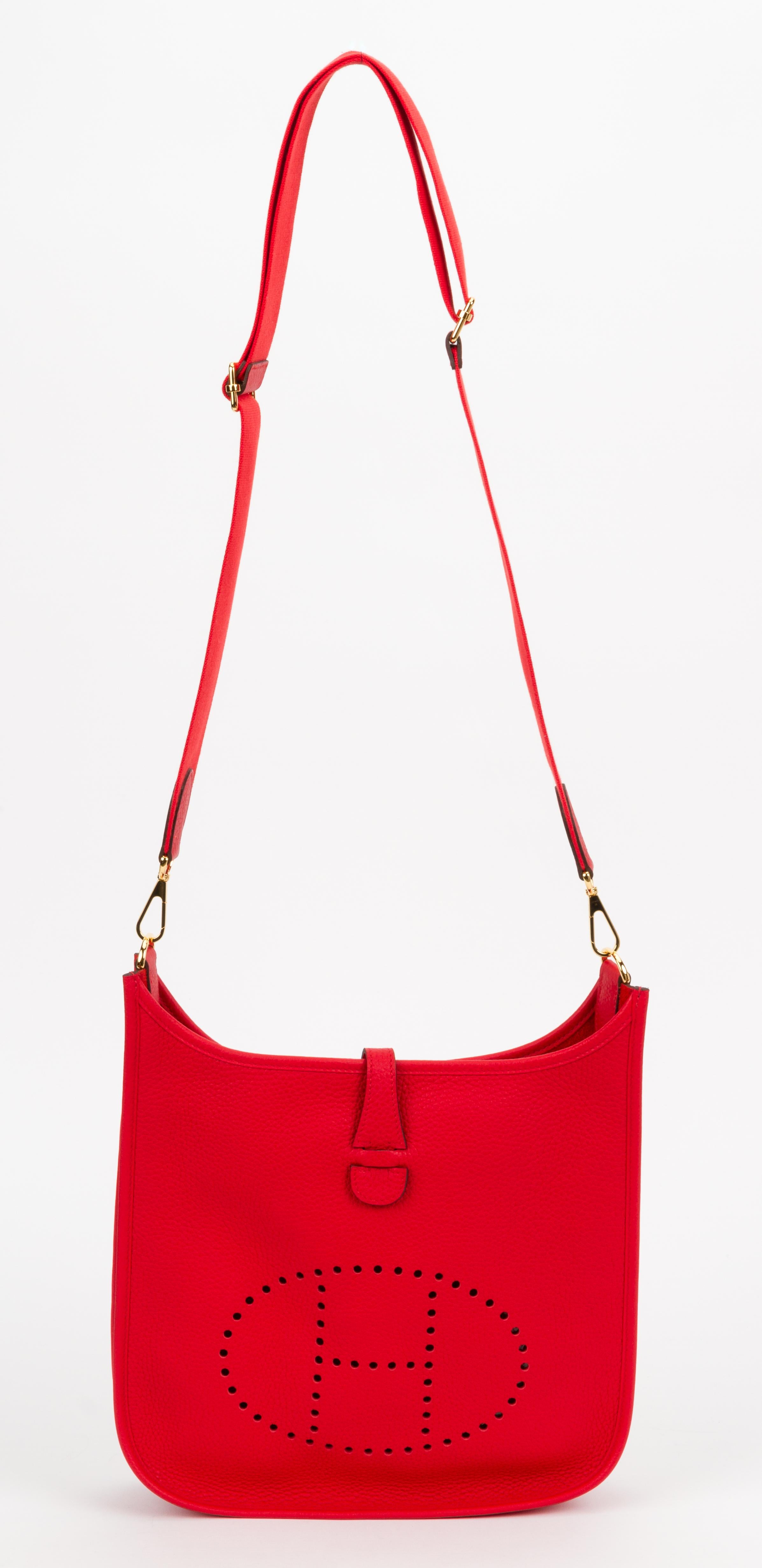 Hermès brand new 2020 color rouge de couer clemence leather medium Evelyne bag with gold tone hardware. Adjustable shoulder strap, can be worn cross body. Date stamp AT for 2020. Comes with 2 original dusters, shoulder strap, box, and ribbon.