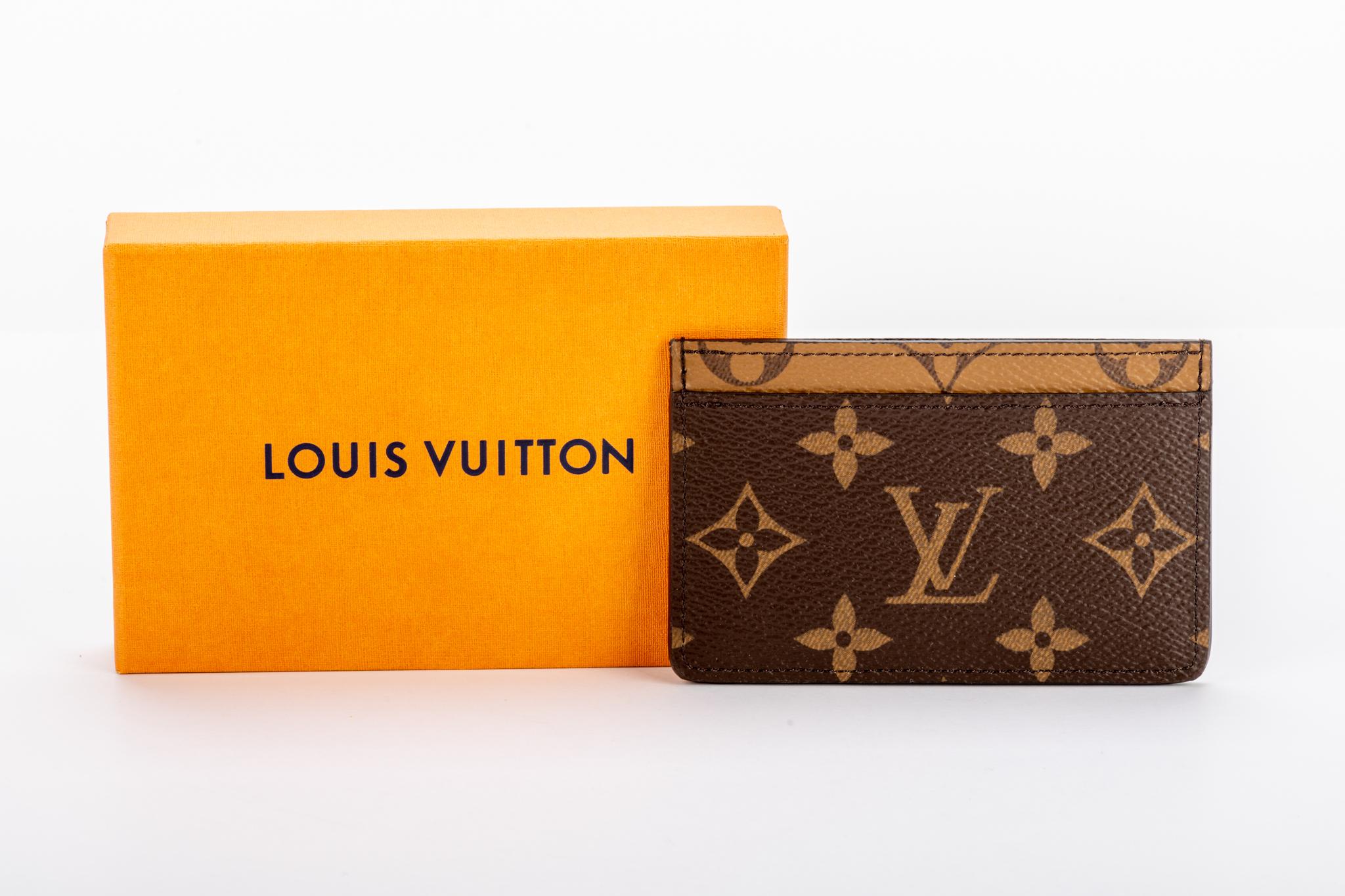 Vuitton two tone coated canvas monogram credit card case. Comes with original box.