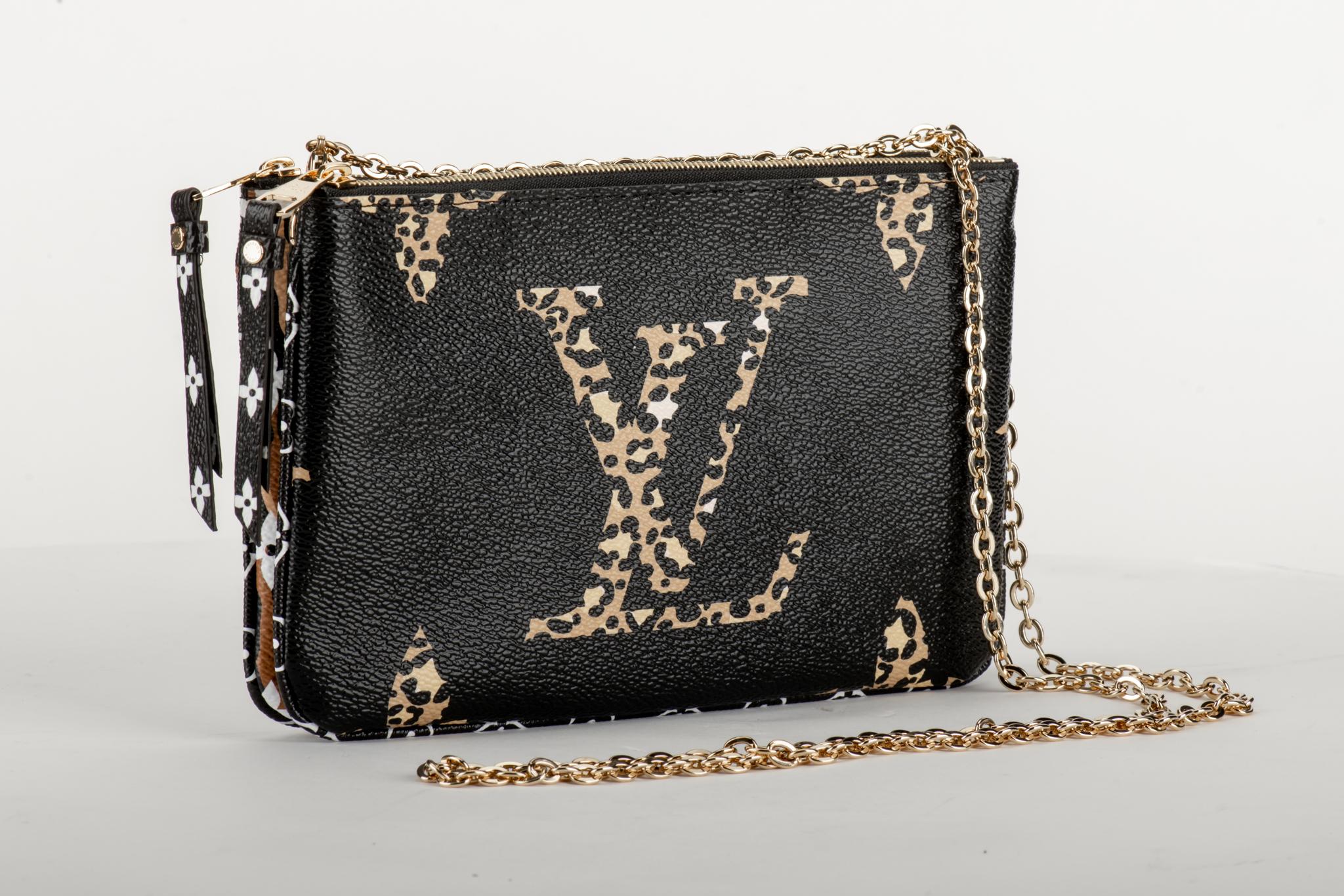 Louis Vuitton limited edition double pouchette in coated monogram canvas with animalier details. Double zipped compartments with middle open pocket, can be used as a pouchette or as a crossbody. Comes with original dust cover and box. Never worn.
