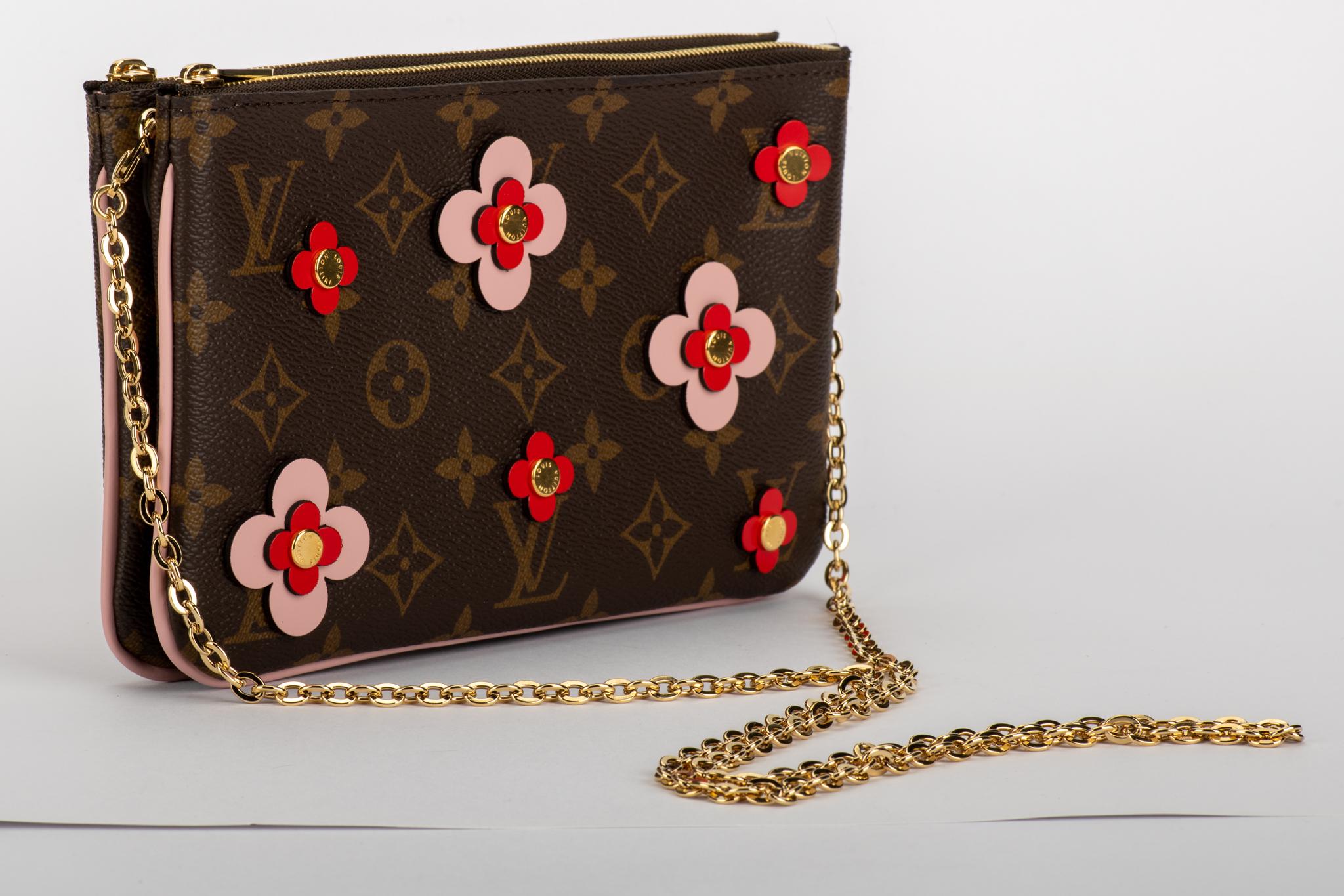 Louis Vuitton double pouchette in coated monogram canvas with pink and red flowers. Double zipped compartments with middle open pocket, can be used as a pouchette or as a crossbody. Comes with original dust cover. Never worn.