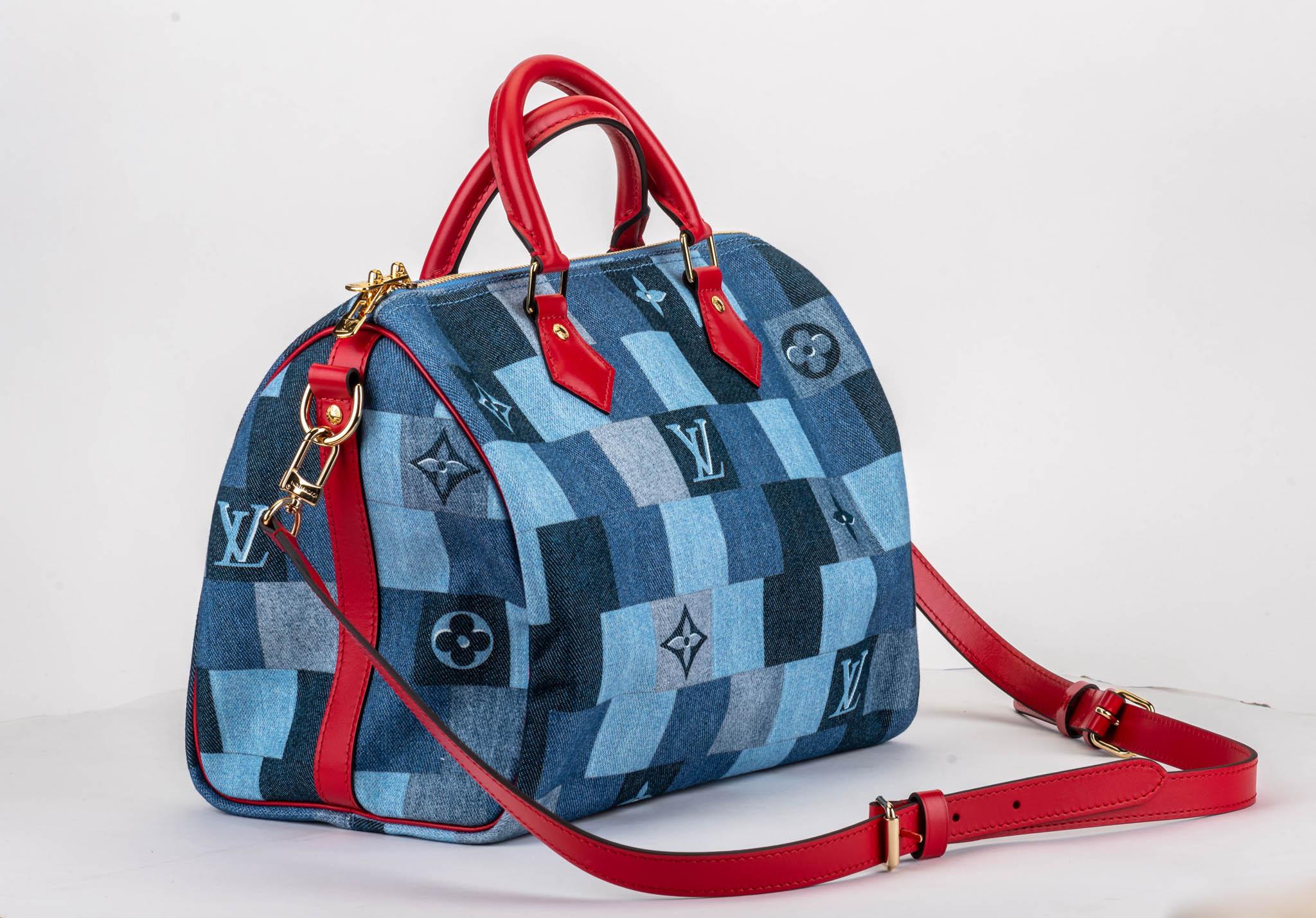Louis Vuitton limited edition speedy 30 bandouliere in denim print. Red leather details and gold tone hardware. Comes with dust cover and original box.