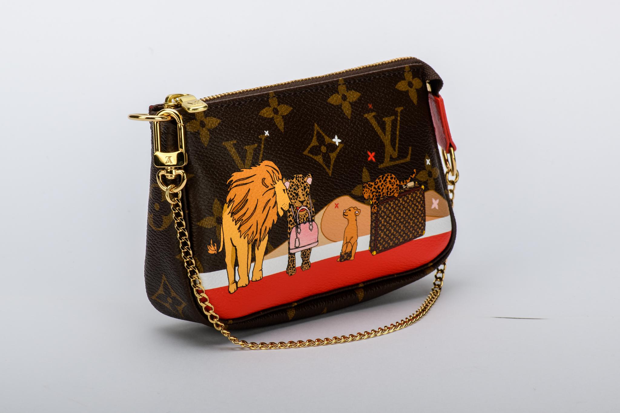 Louis Vuitton limited edition Christmas 2018 mini pouchette. Monogram canvas with lions and ghepards. Comes with original dust cover and box.
