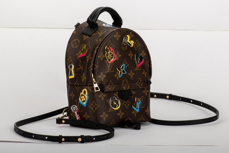 Louis Vuitton limited edition multicolor logos mini backpack. Monogram signature canvas with black leather straps. External zipped pocket, internal open pocket. Comes with serial number, dust cover and box.
