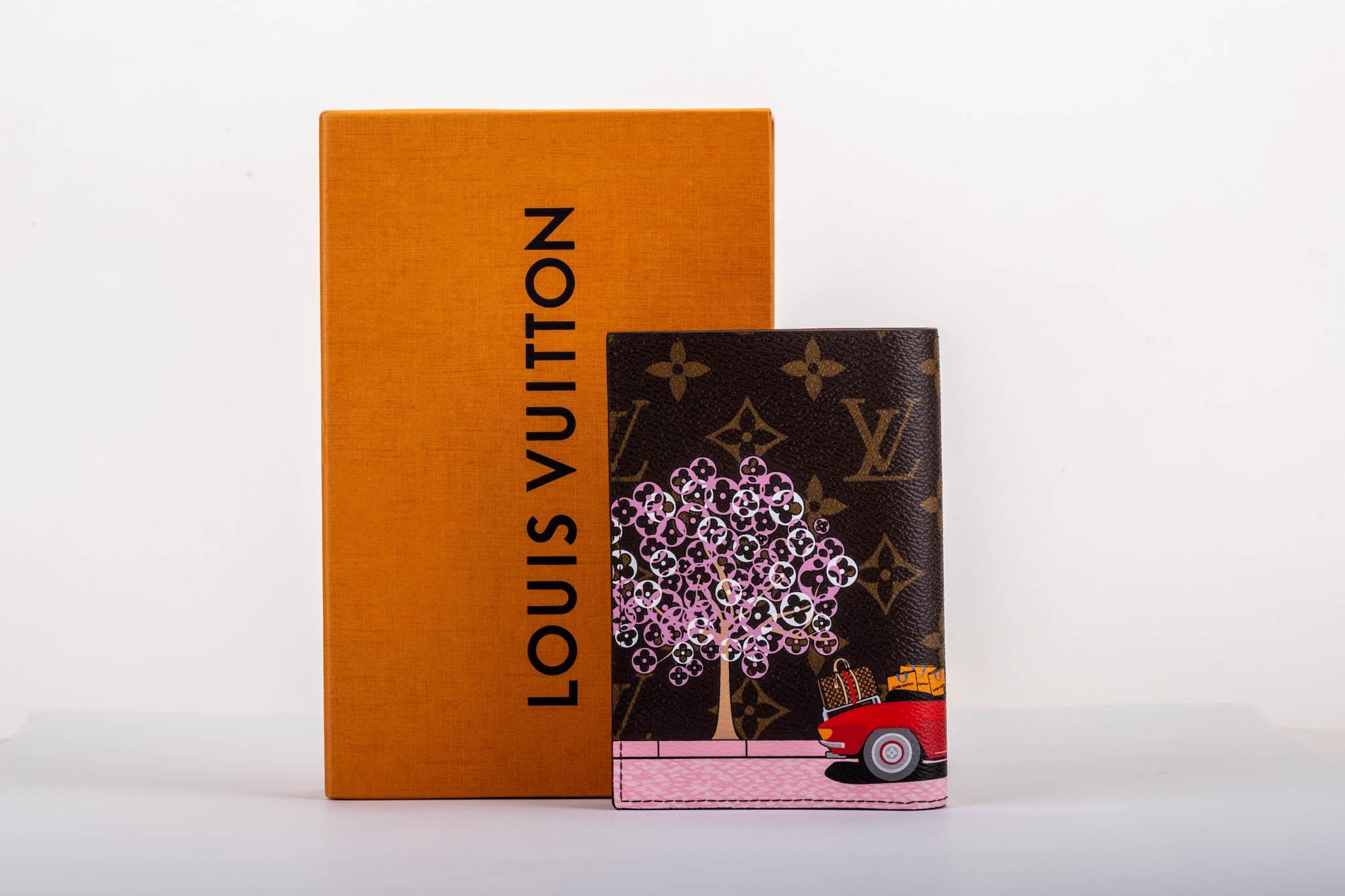 Louis Vuitton Sold Out Christmas 2019 limited edition Paris passport cover. Coated monogram canvas with contrast red interior leather. Comes with dust cover and box.